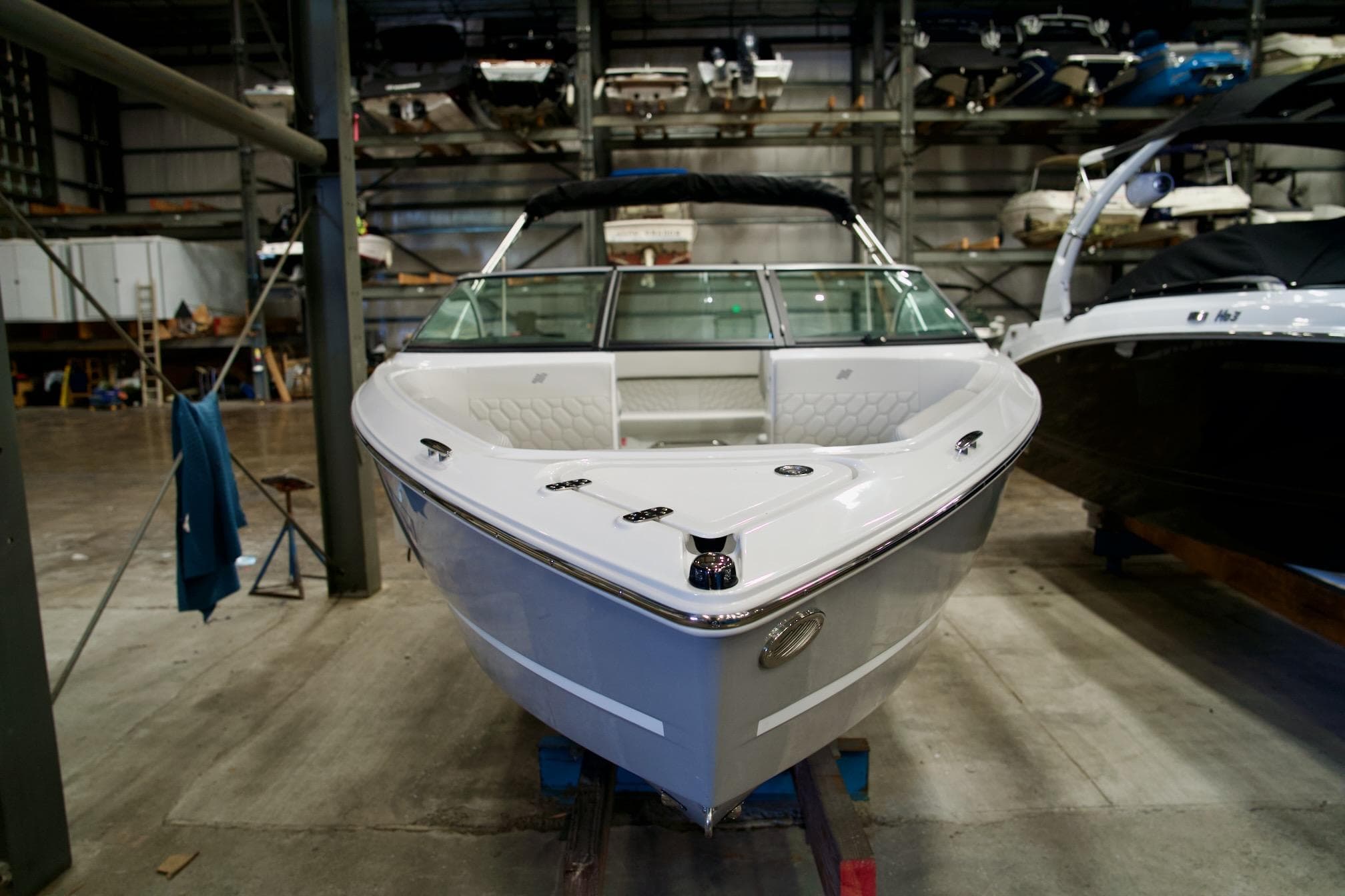 2026 Four Winns H2 boat in a storage facility, showcasing sleek design and modern features.