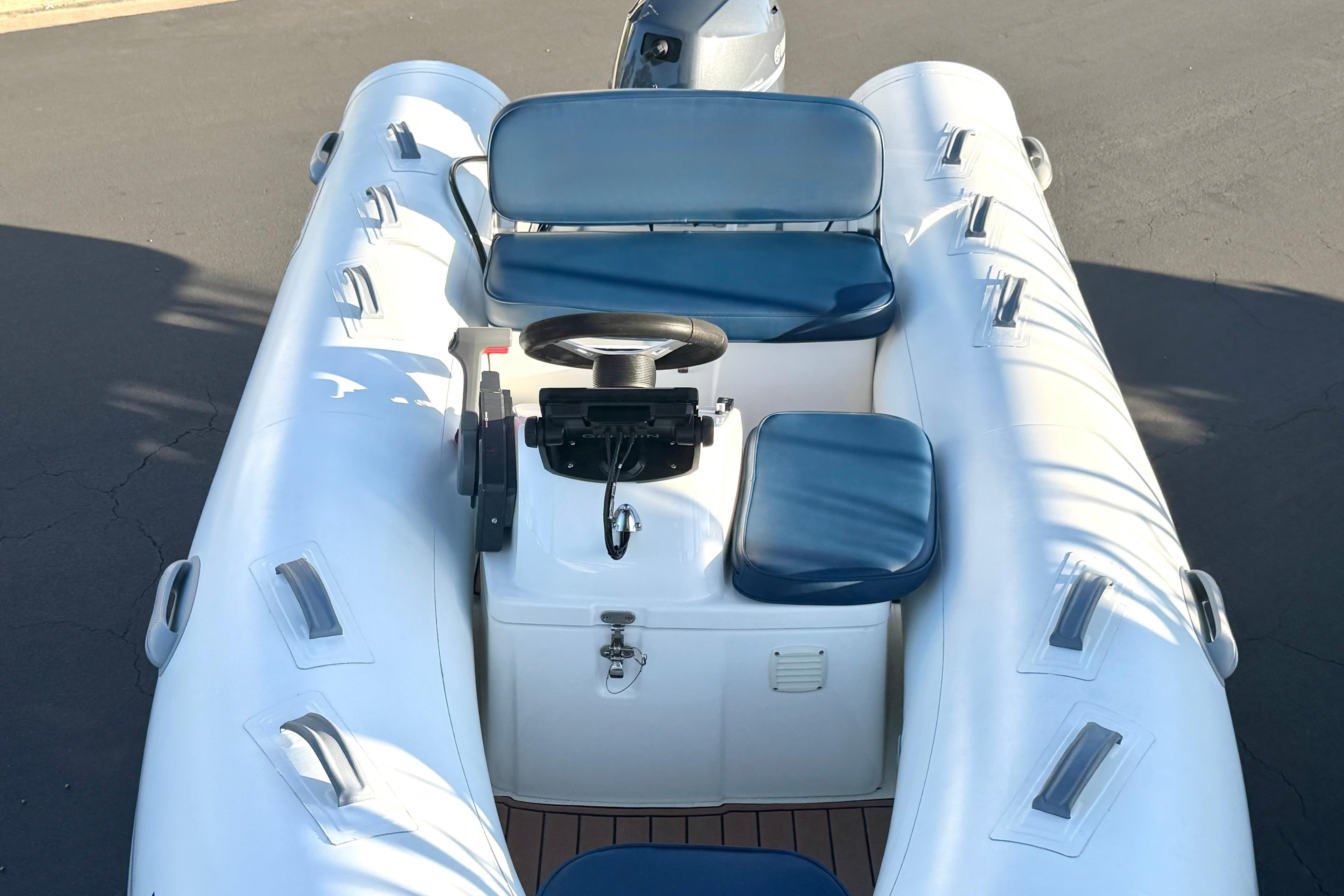 2018 Brig Falcon 360 inflatable boat with blue seating and steering console.