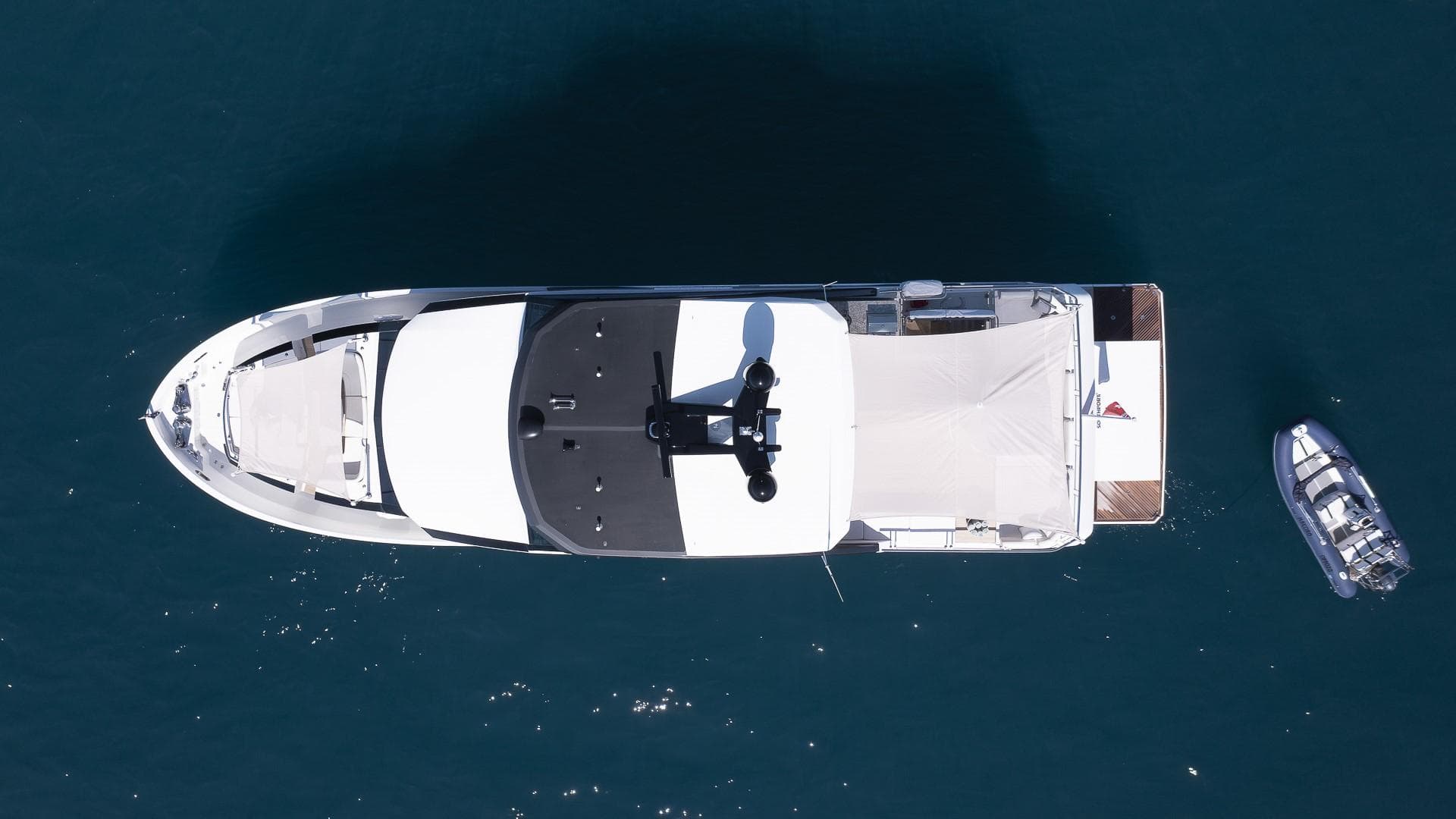 Aerial view of 2020 Ocean Alexander 26 R Enclosed Bridge yacht on blue water.