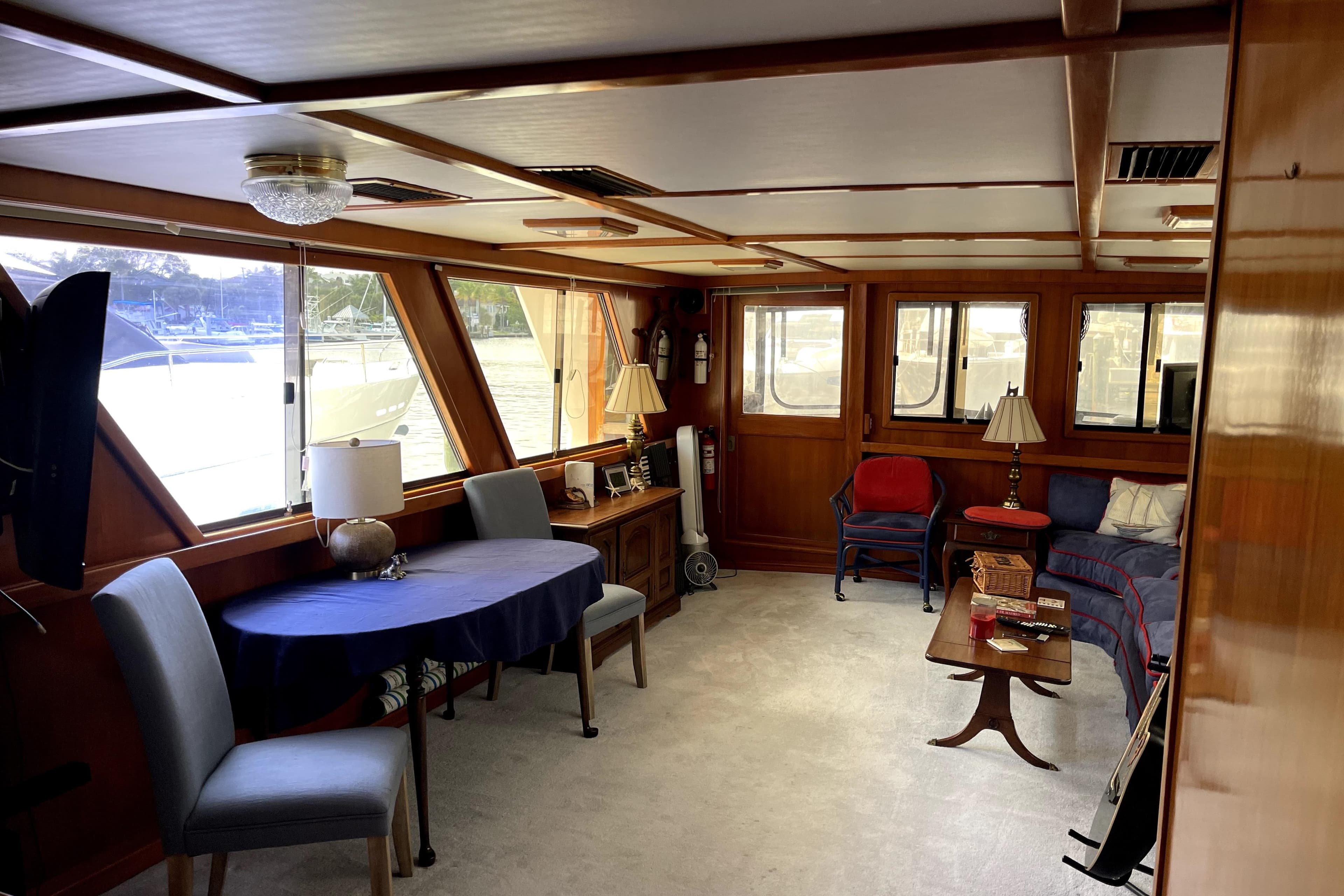 Interior of 1988 Jefferson Marquessa 60 MY yacht, featuring elegant wood paneling and cozy seating.