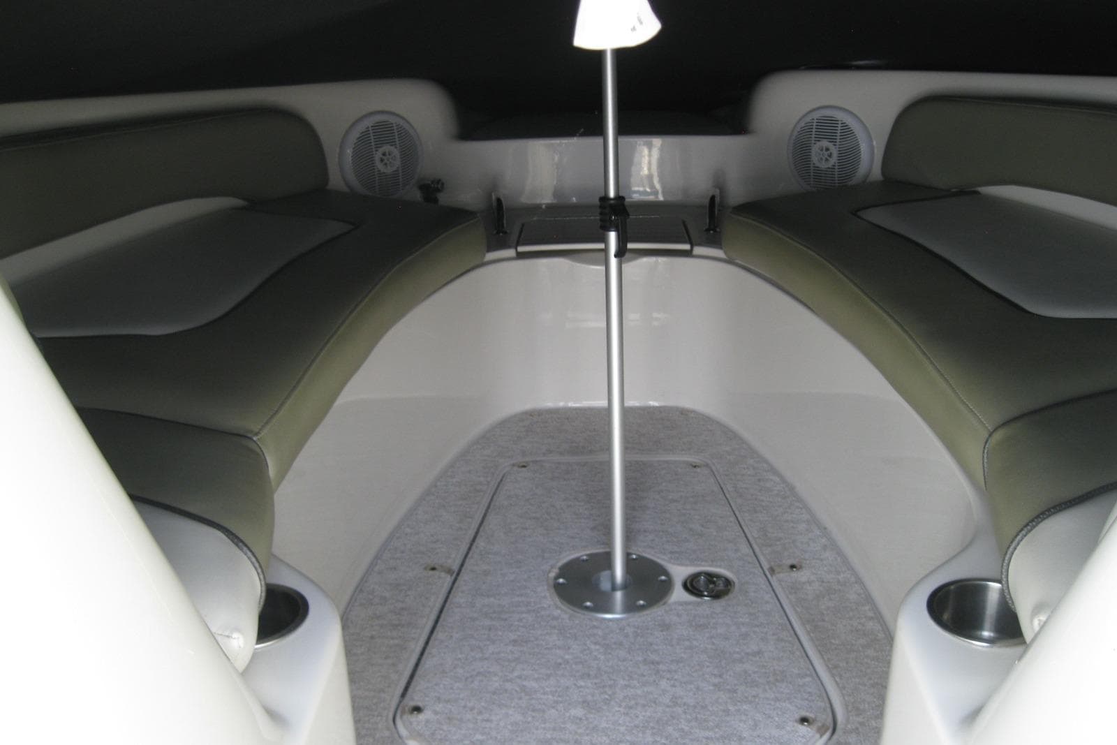 Interior view of a 2006 Sea Ray 240 Sundeck boat with cushioned seating.