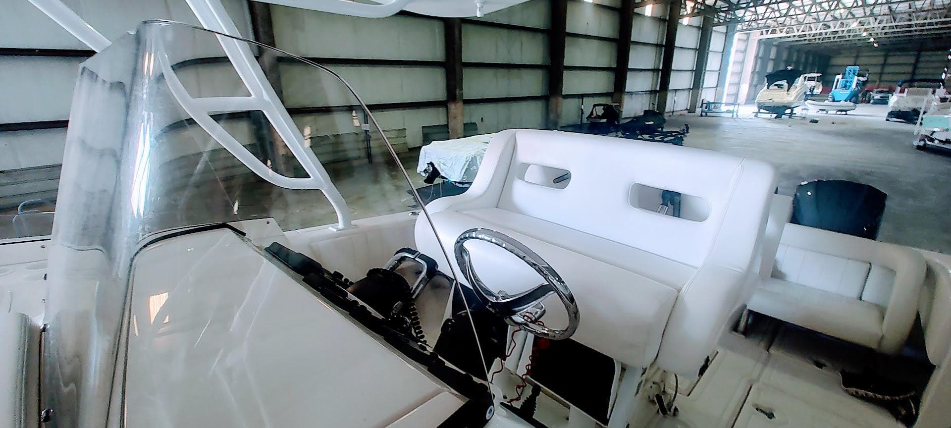 2012 Intrepid 400 Cuddy boat interior with steering wheel in a spacious warehouse.