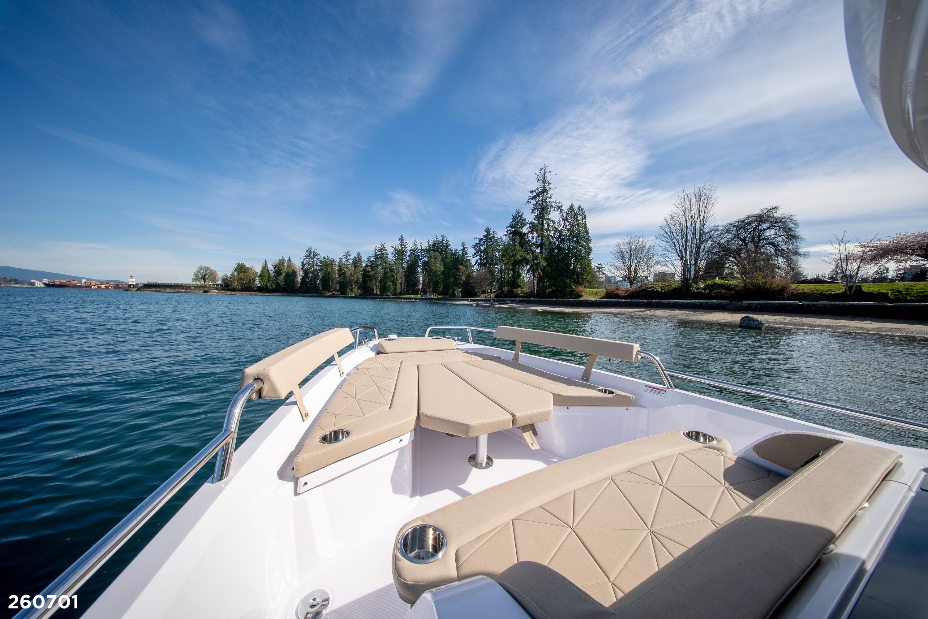 2026 Axopar 29 XC Cross Cabin boat on serene water with scenic shoreline.