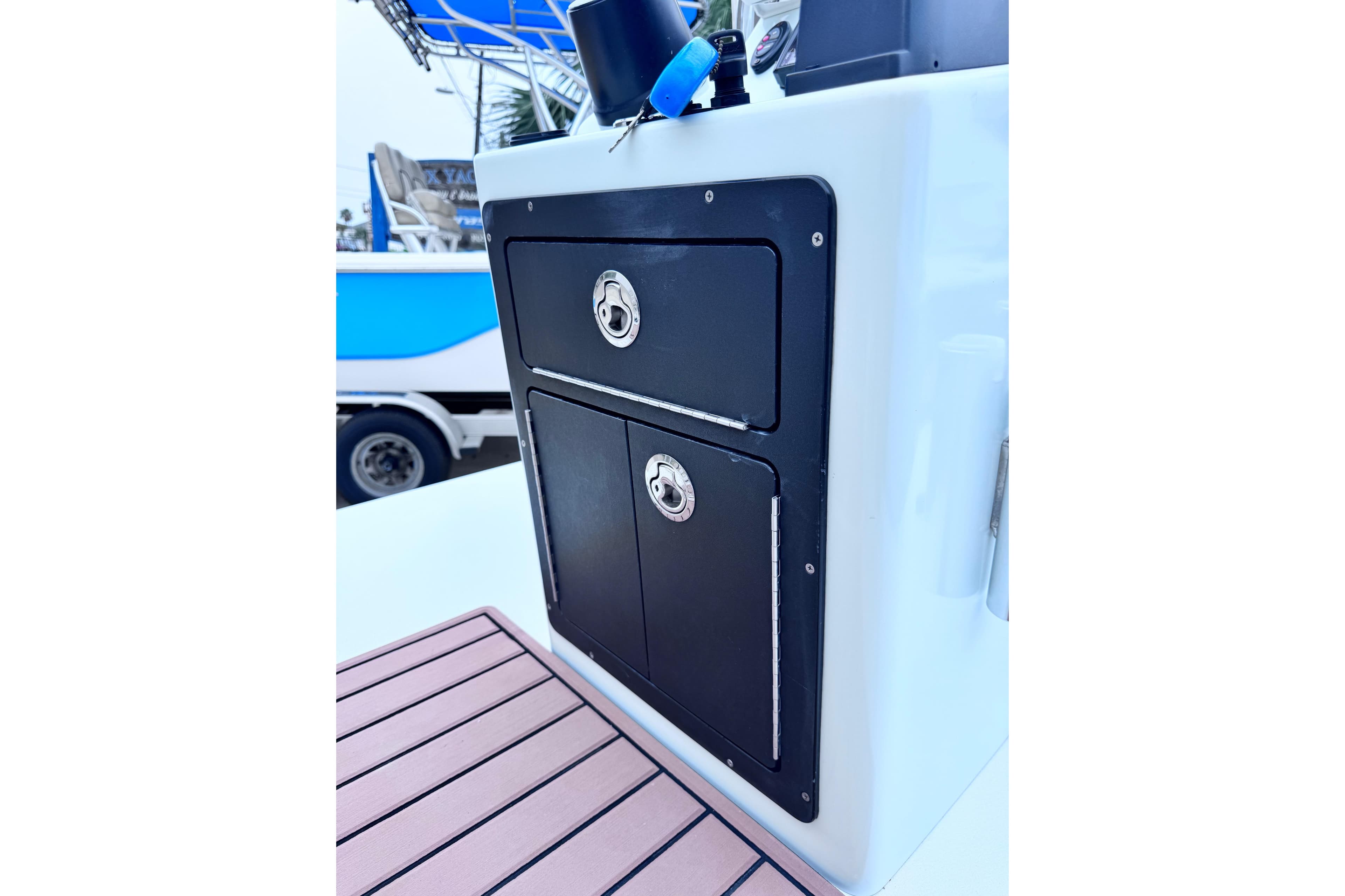 2016 East Cape Fury boat console with storage compartments and teak flooring.