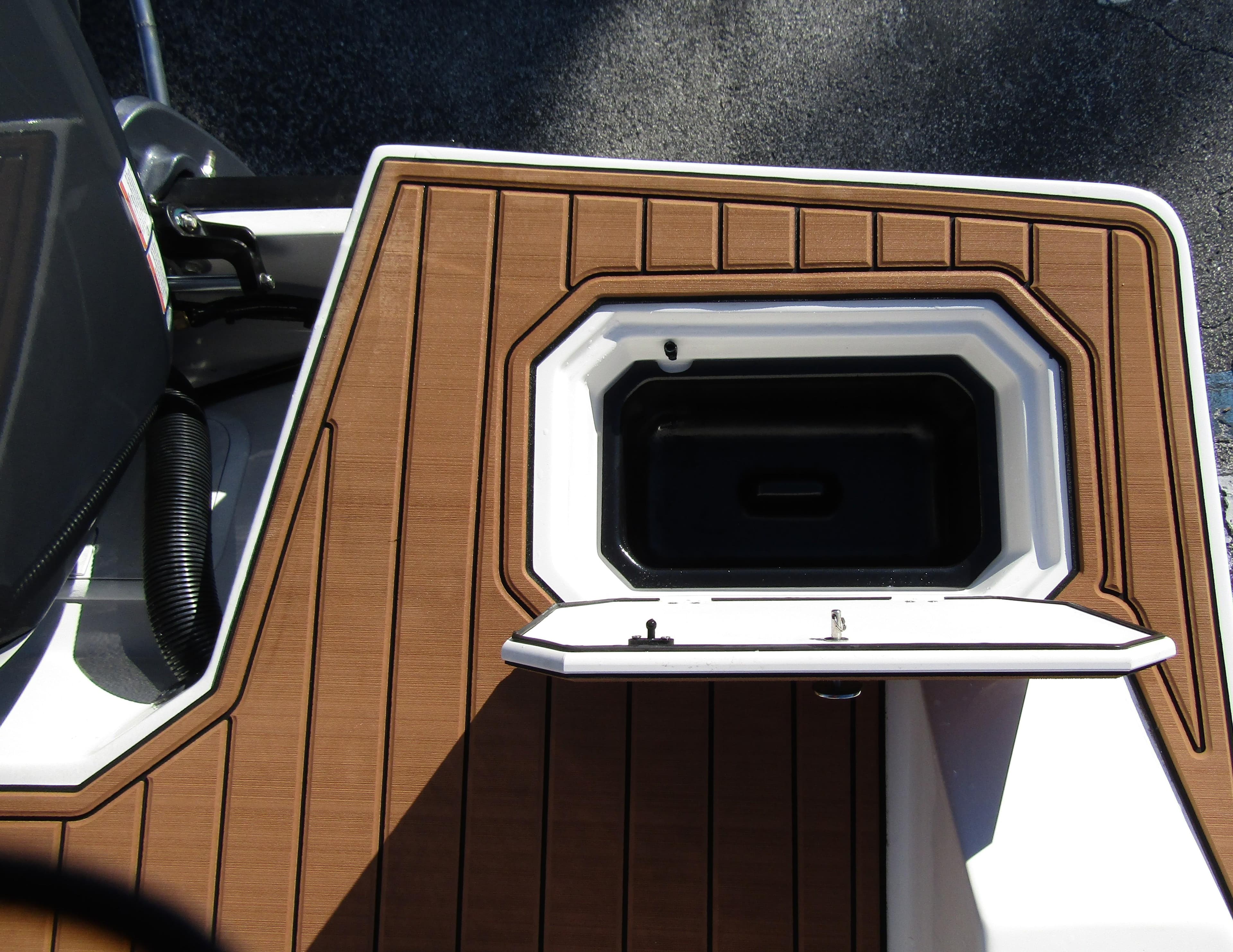 2024 Starcraft SVX 231 OB CC boat deck with storage compartment.