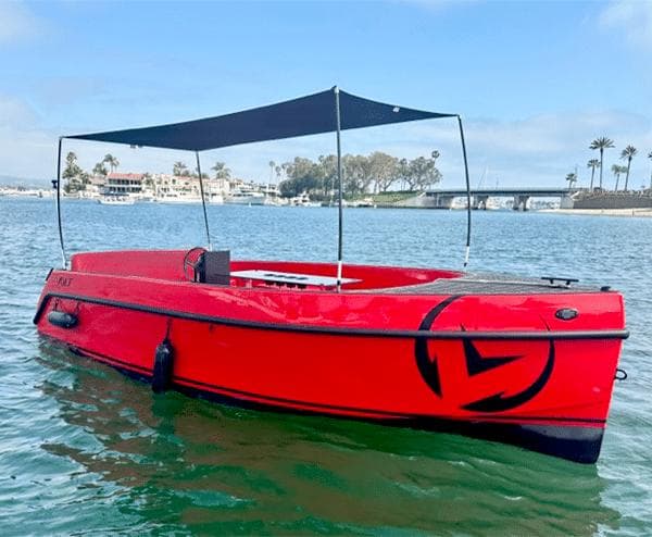 2023 Vision Marine Technologies Volt 180 boat on water, featuring a sleek red design.