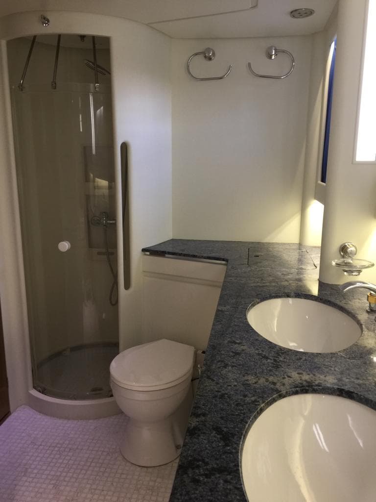 Luxury yacht bathroom with dual sinks, shower, and toilet in a 1991 Jongert 2900S.