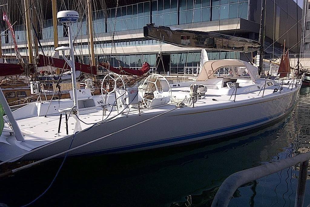 1995 McConaghy Reichel Pug 79 yacht docked at a marina, showcasing sleek design.