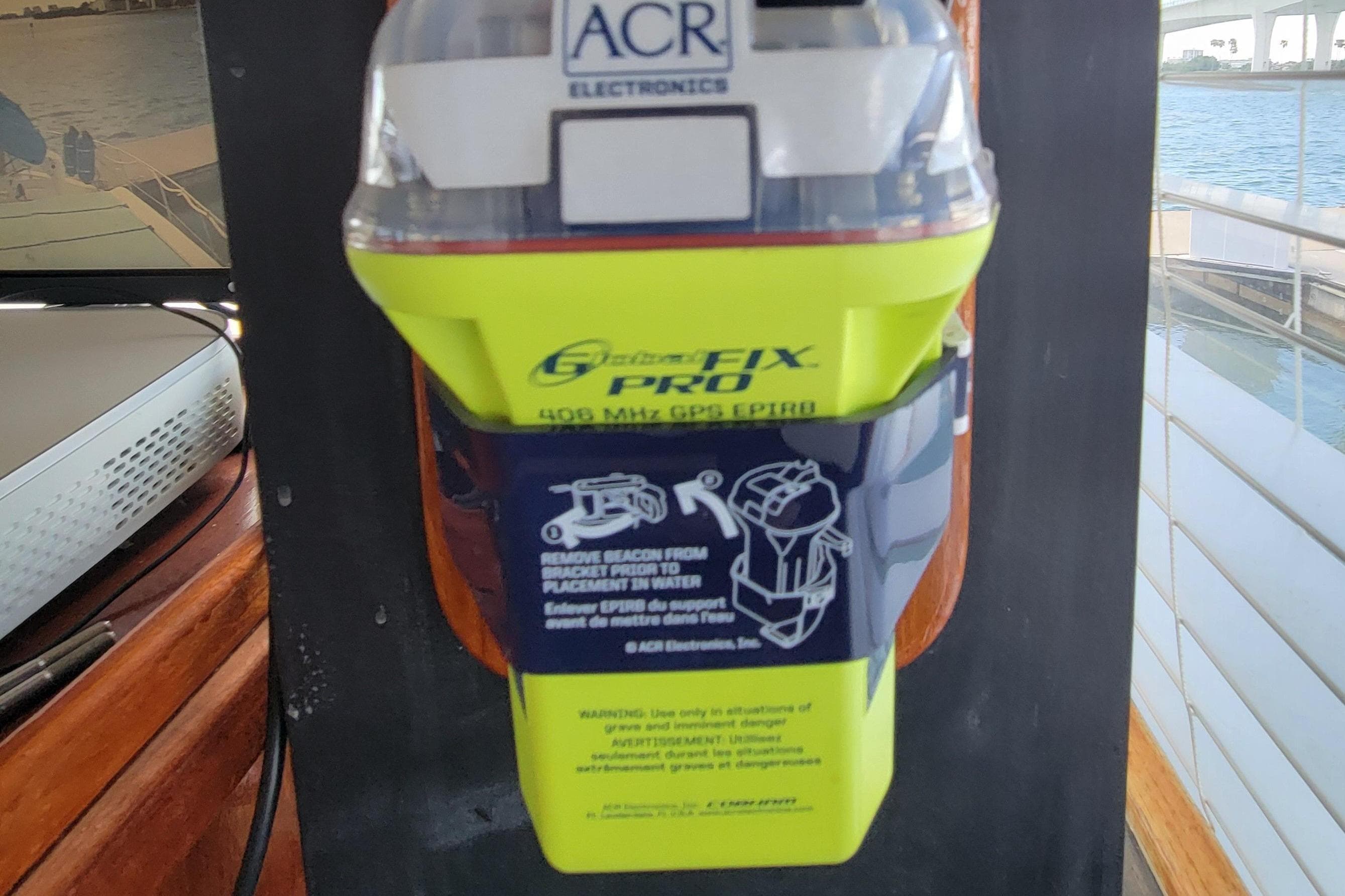 ACR Electronics beacon on 1985 Chris-Craft 500 Constellation yacht, docked by water.