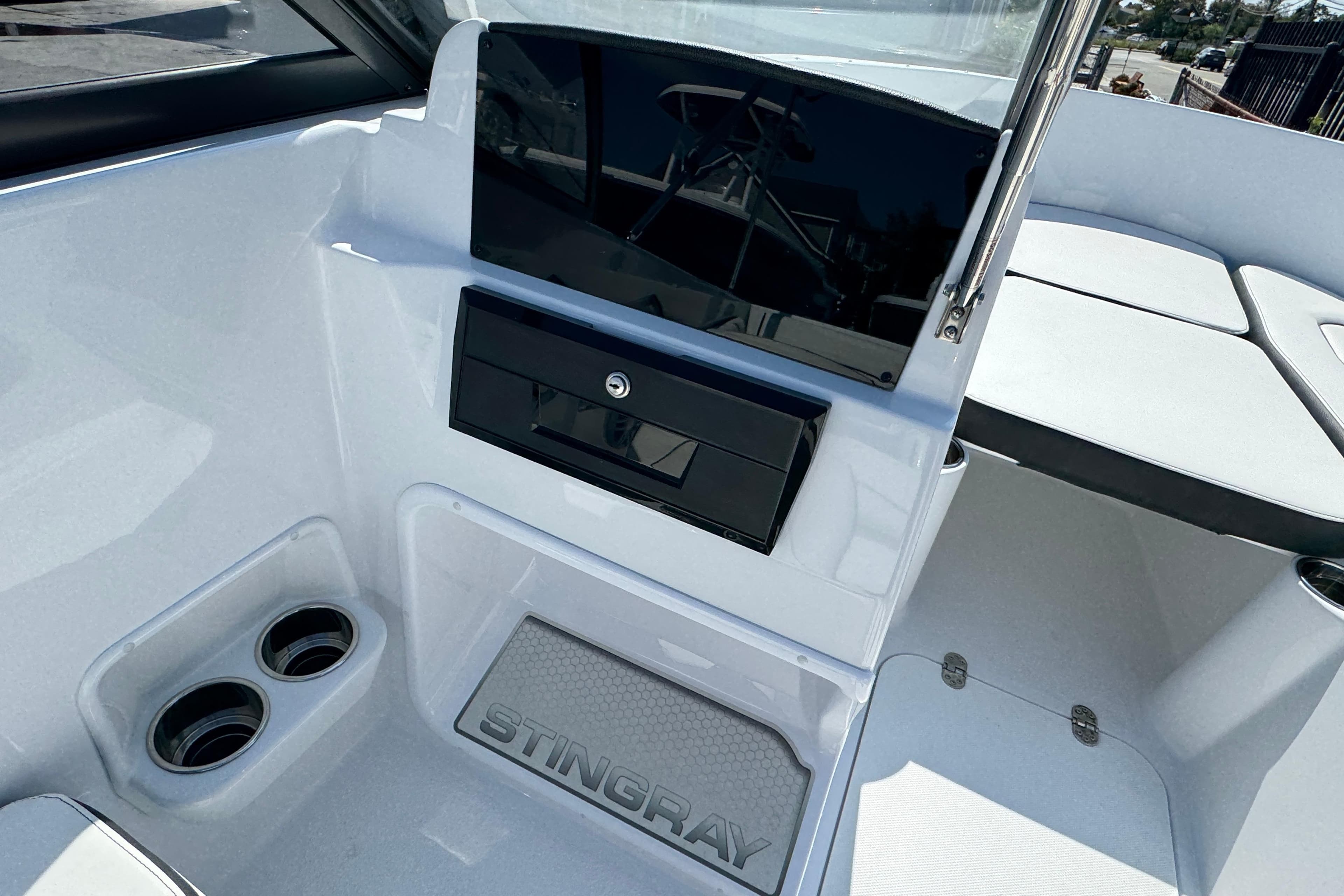 2026 Stingray 172 SC boat interior with cup holders and storage compartment.