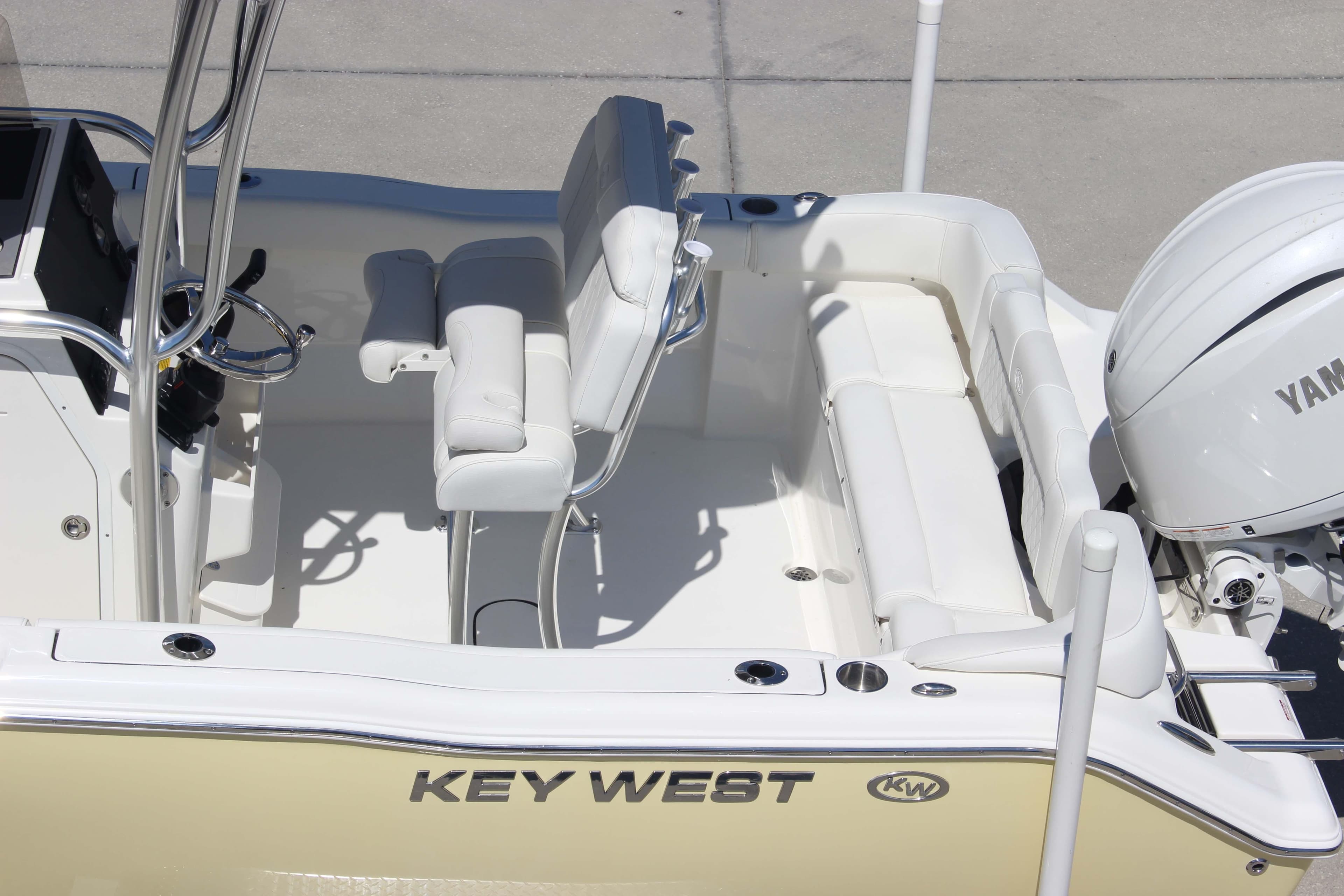 2026 Key West 203 FS boat interior with Yamaha engine, featuring white seating and steering console.