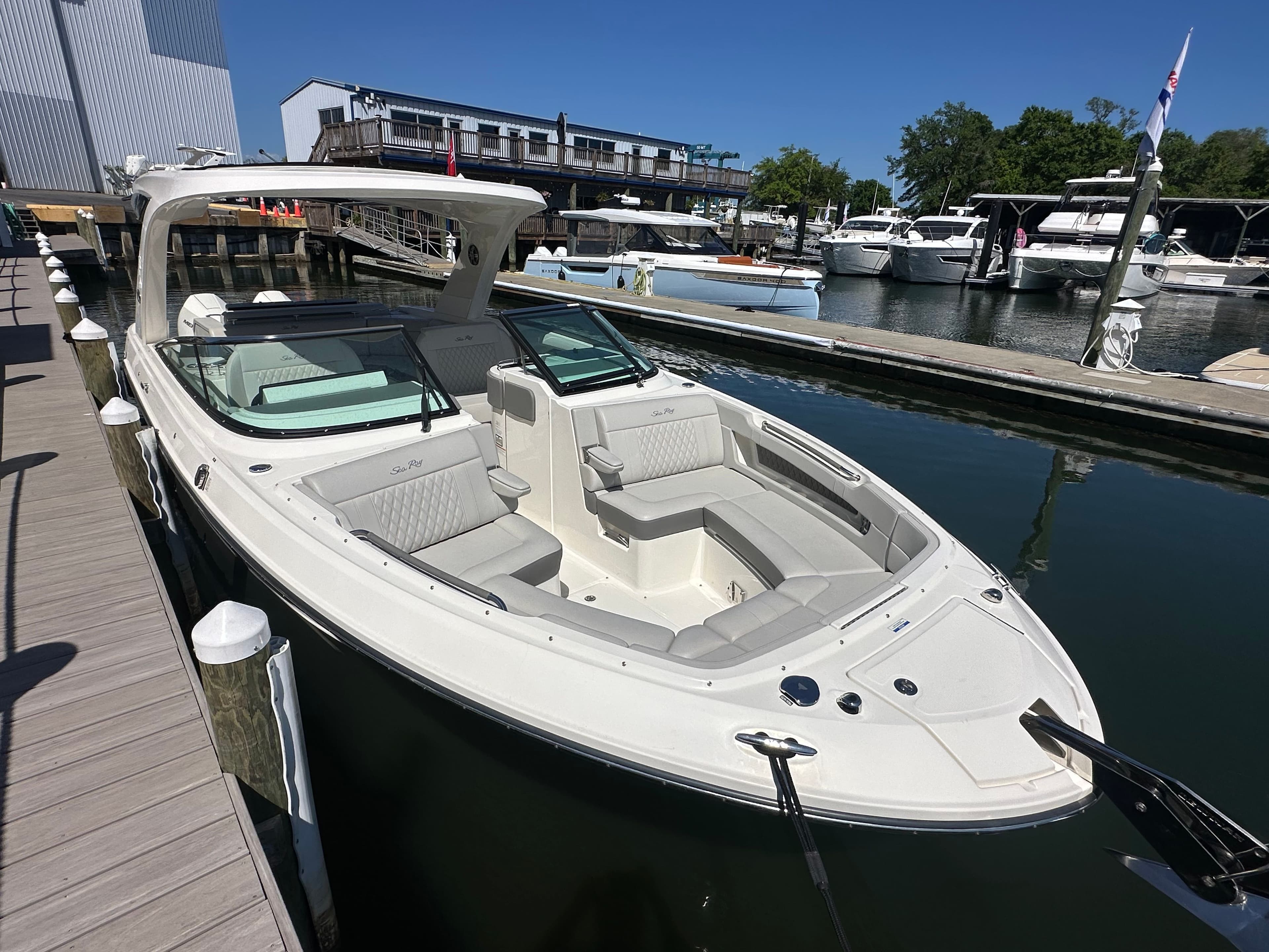 2023 Sea Ray SLX 310 Outboard at dock, luxury motorboat.