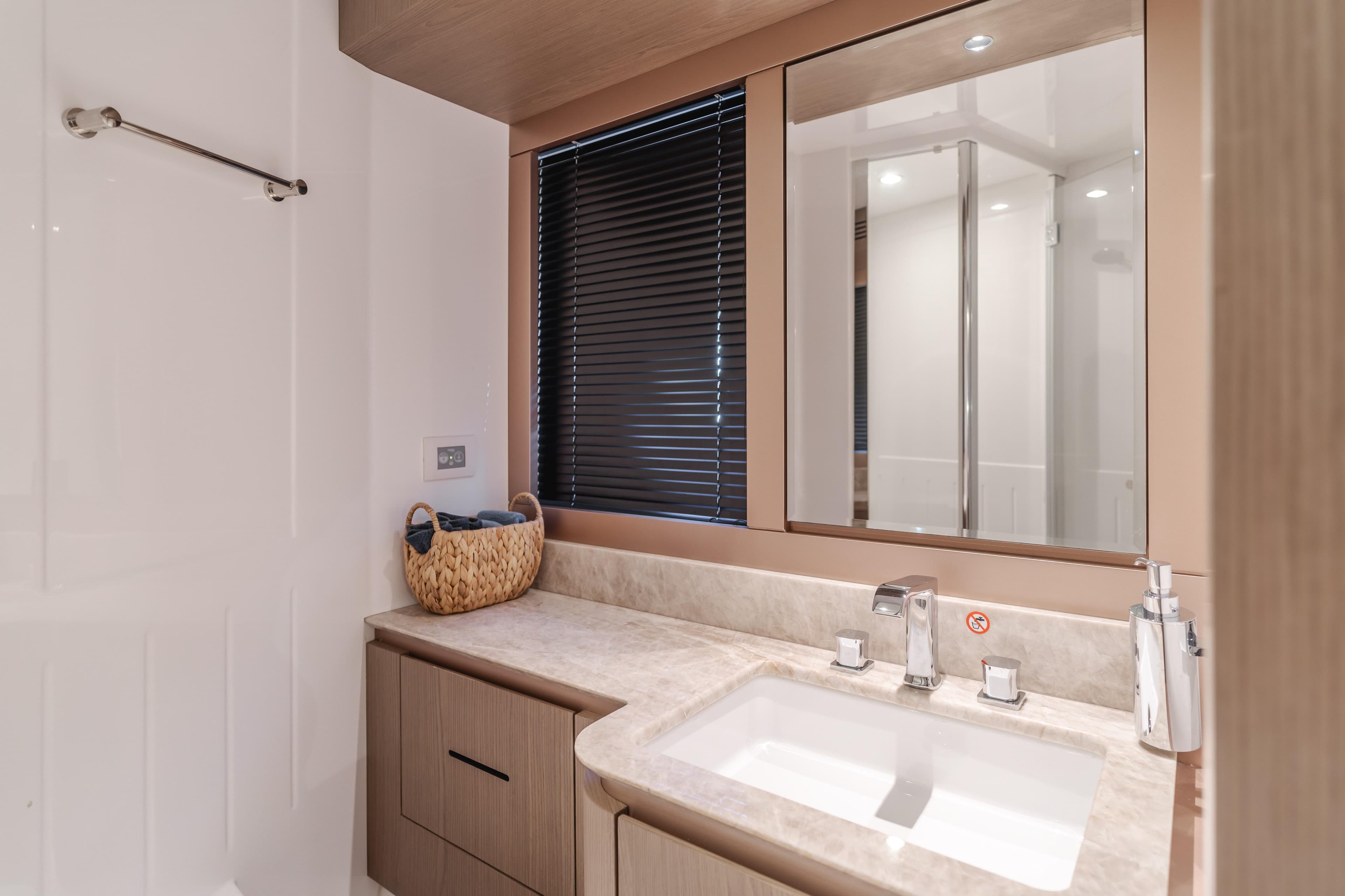 Luxurious bathroom in 2023 Azimut Magellano 66 yacht with modern fixtures and elegant design.
