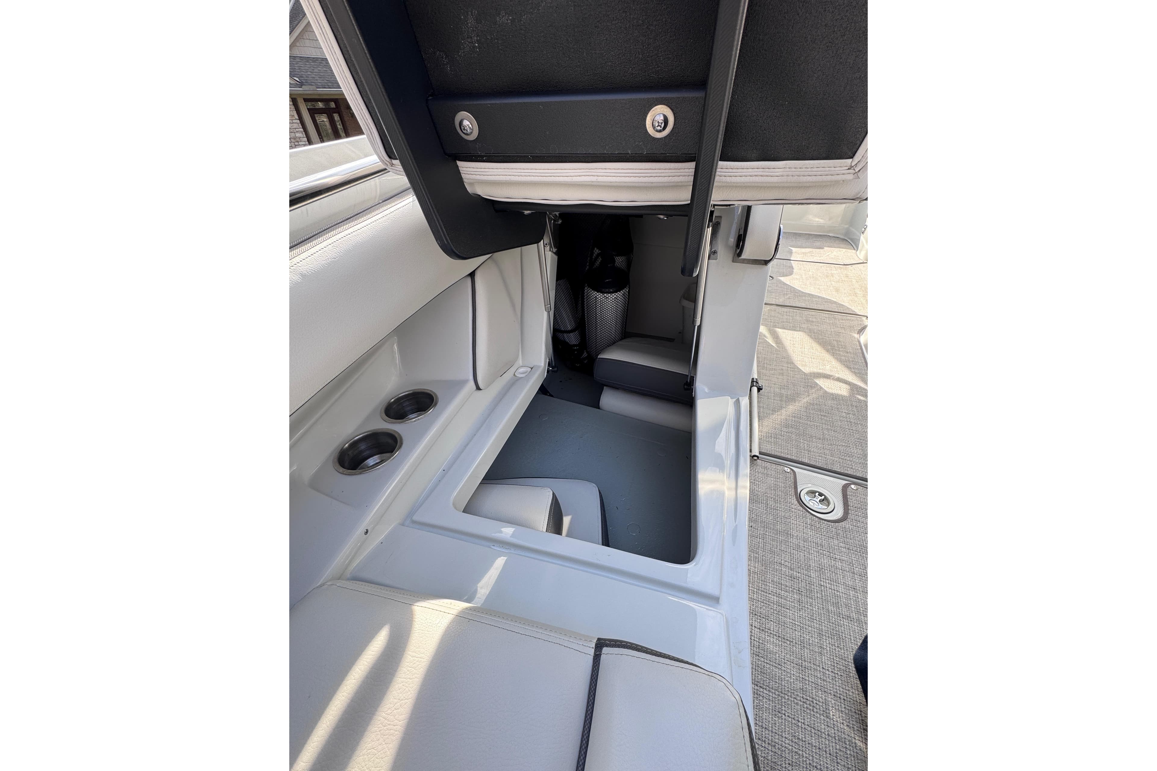 2022 Crownline 265 SS boat interior with storage compartment and cup holders.