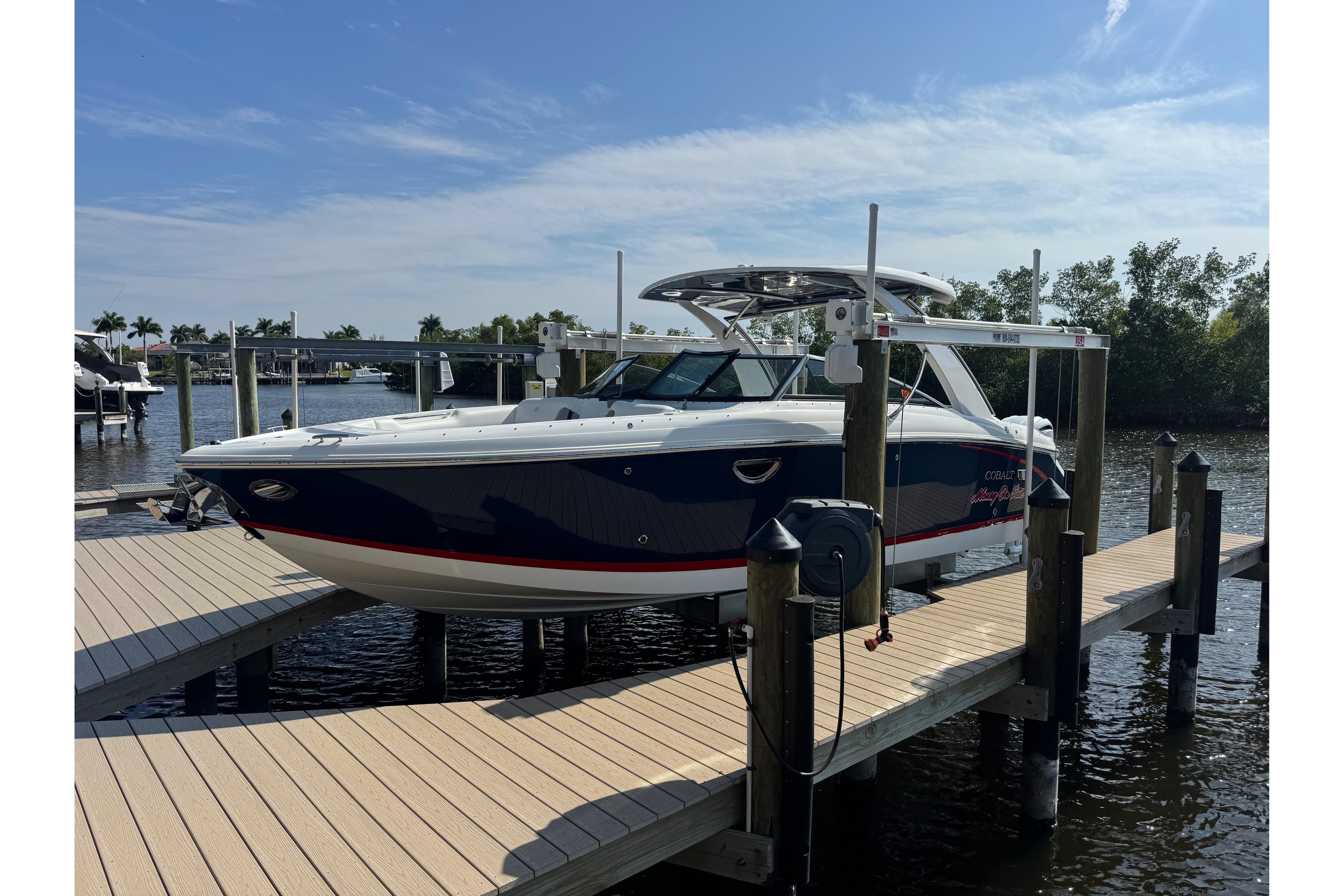 2023 Cobalt 30SC Outboard boat docked on a sunny day.