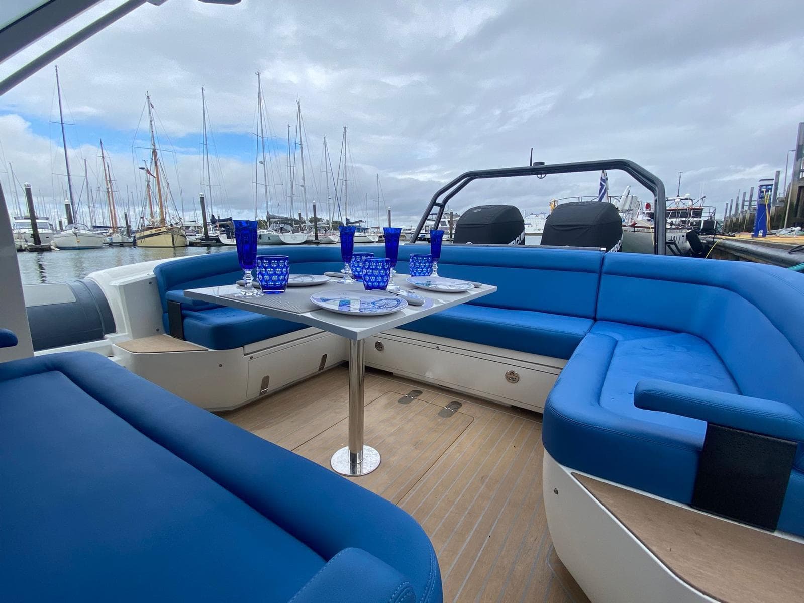 2022 Rib-X Chase RIB with blue seating and table, docked at marina.