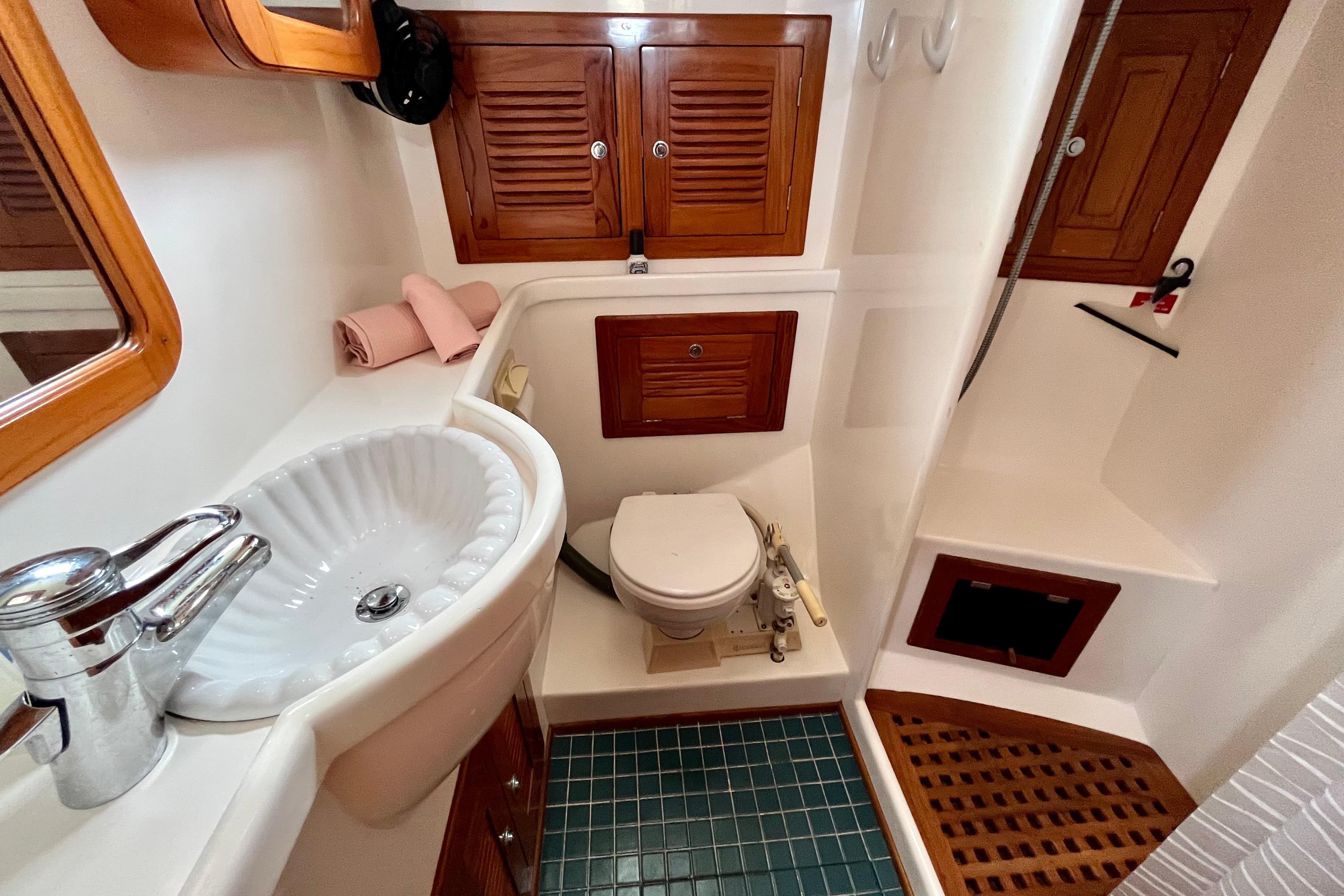 Elegant bathroom in 2000 Cabo Rico 42 yacht with wooden accents and modern fixtures.