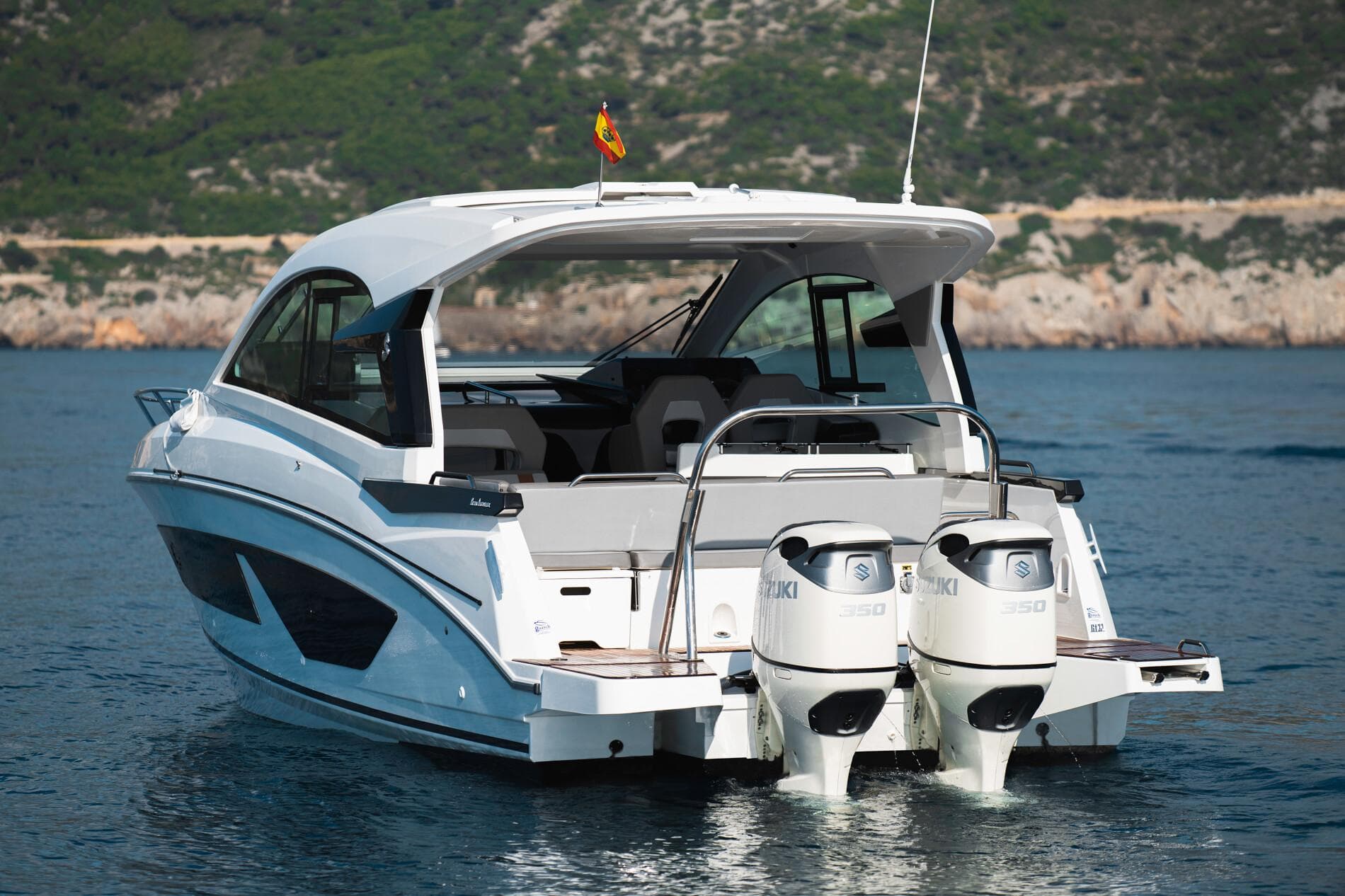 2025 Beneteau 32 Gran Turismo yacht with dual engines on serene water.