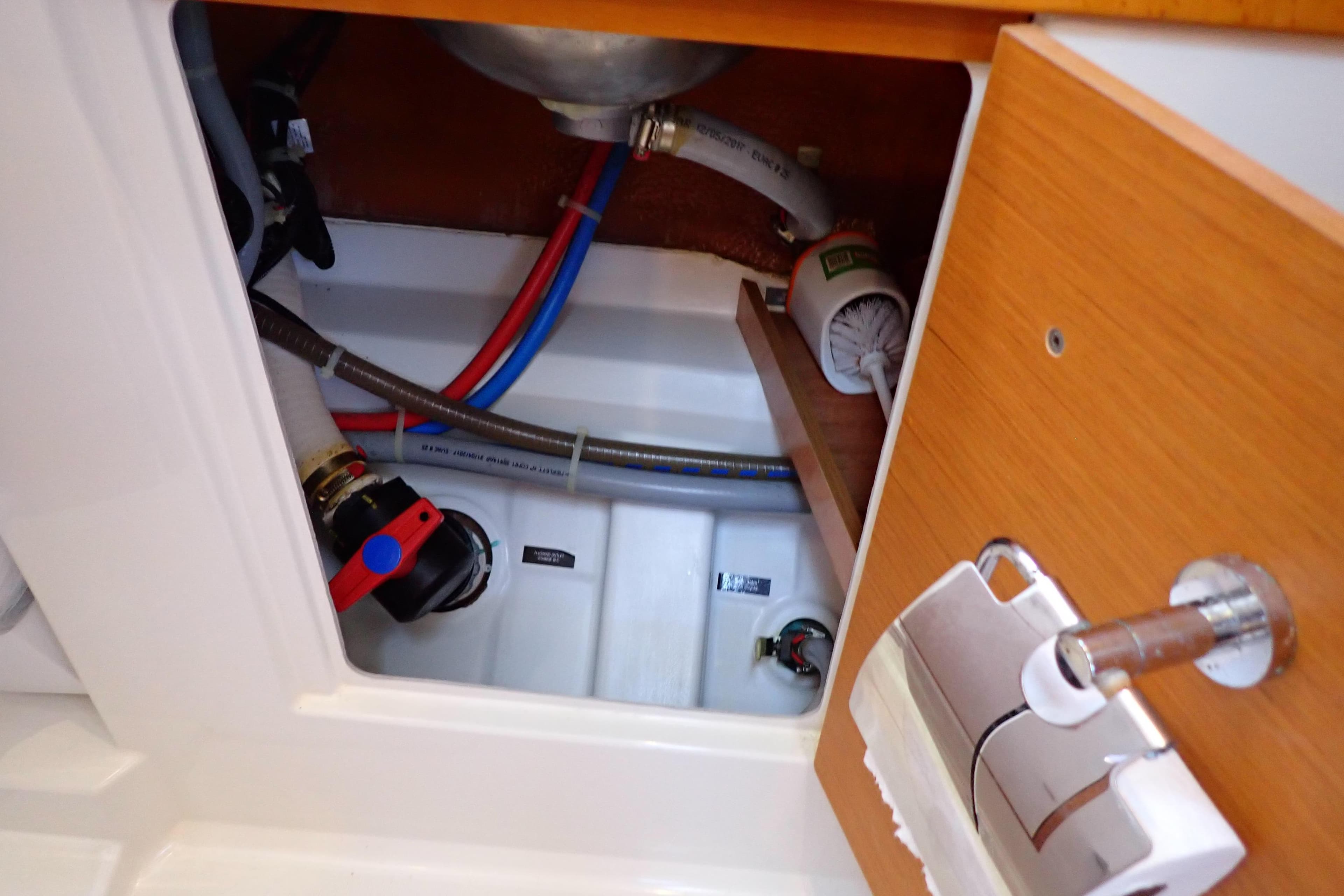 Interior plumbing of 2018 Jeanneau Sun Odyssey 389 sailboat, showing pipes and fittings.