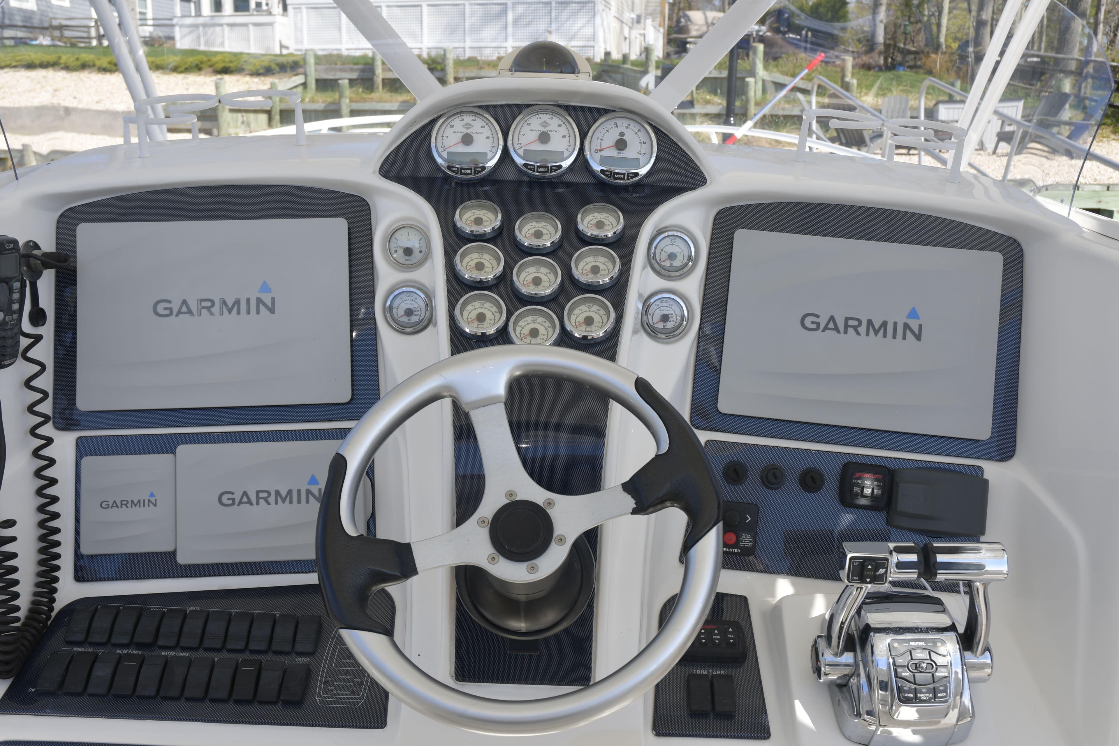 Helm of 2010 Deep Impact 36 TE with Garmin navigation displays and controls.