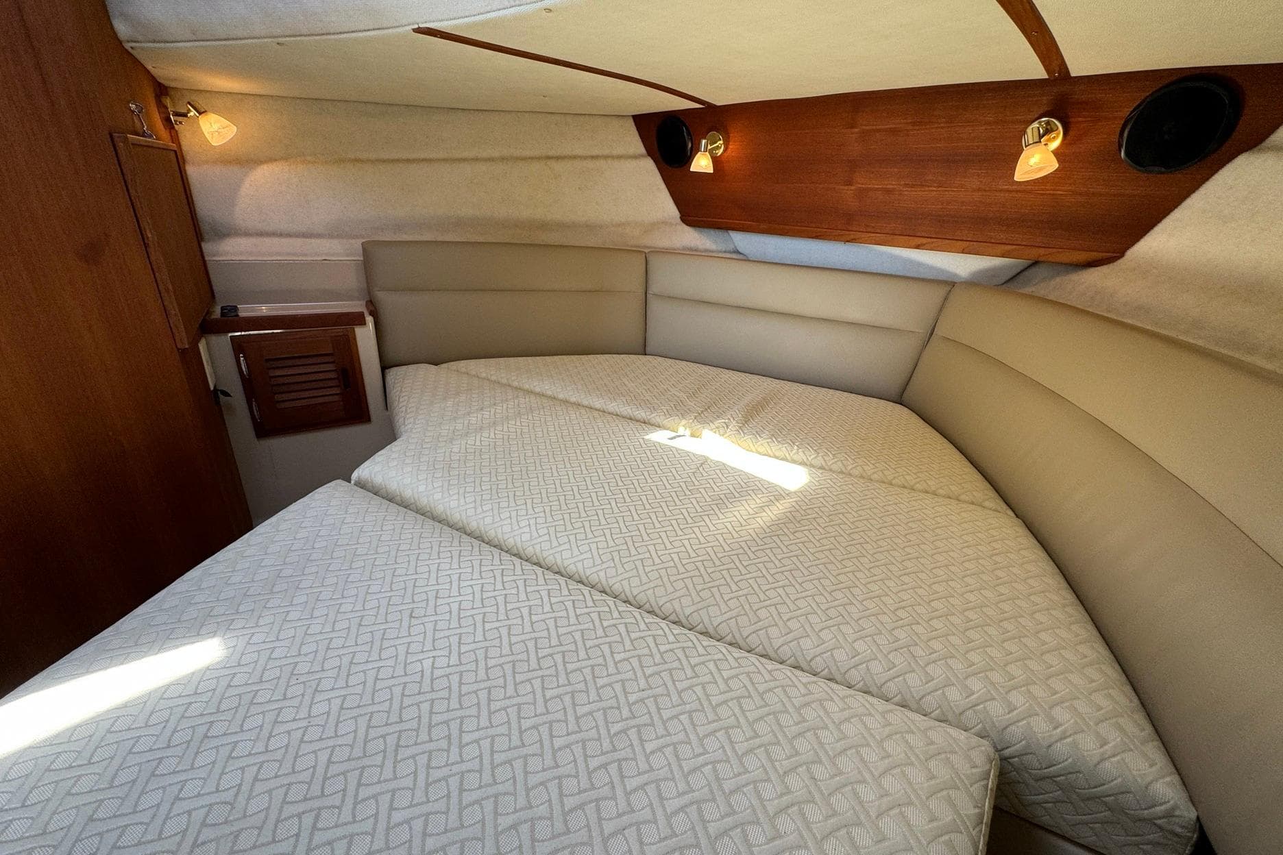 2012 Ranger Tugs R-29 cabin interior with cozy bed and ambient lighting.