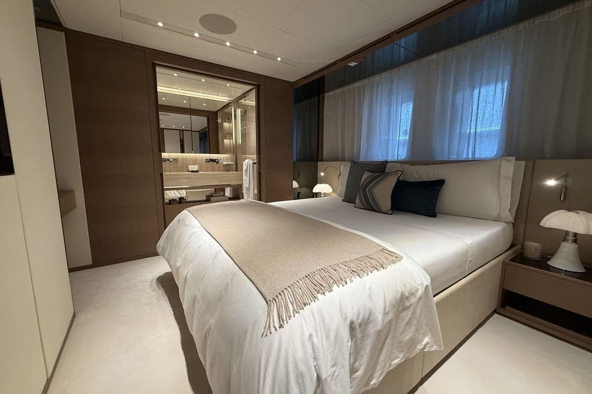 Luxurious bedroom interior on 2023 Sanlorenzo 44Alloy yacht, featuring elegant decor and ambient lighting.
