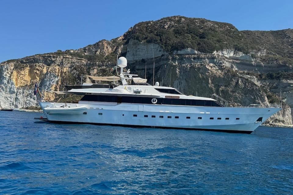 Luxury yacht W.A. Souter & Sons 34, 1984, cruising near rocky coastline.