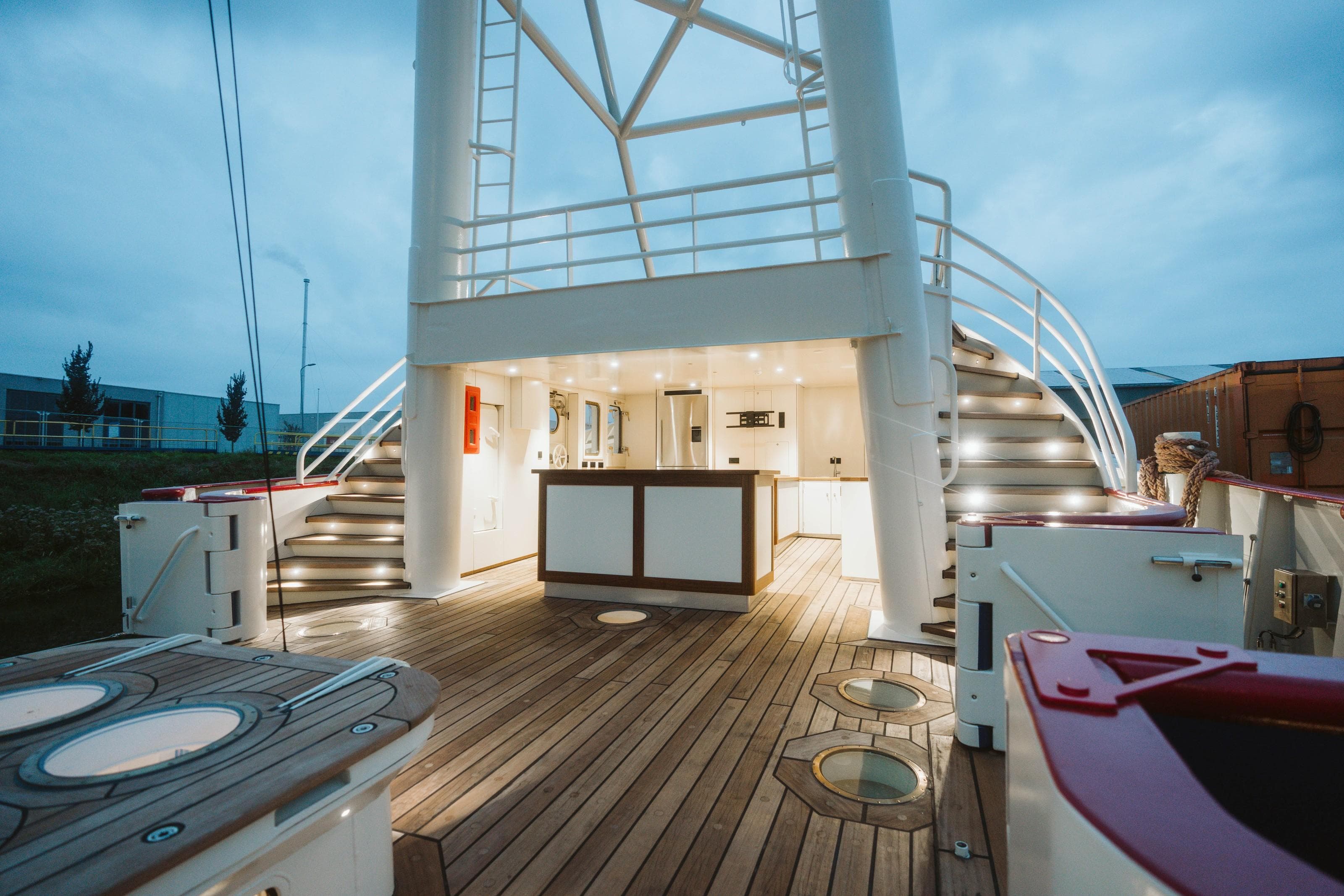 Luxurious 1988 Damen Custom yacht deck with modern lighting and elegant wooden flooring.