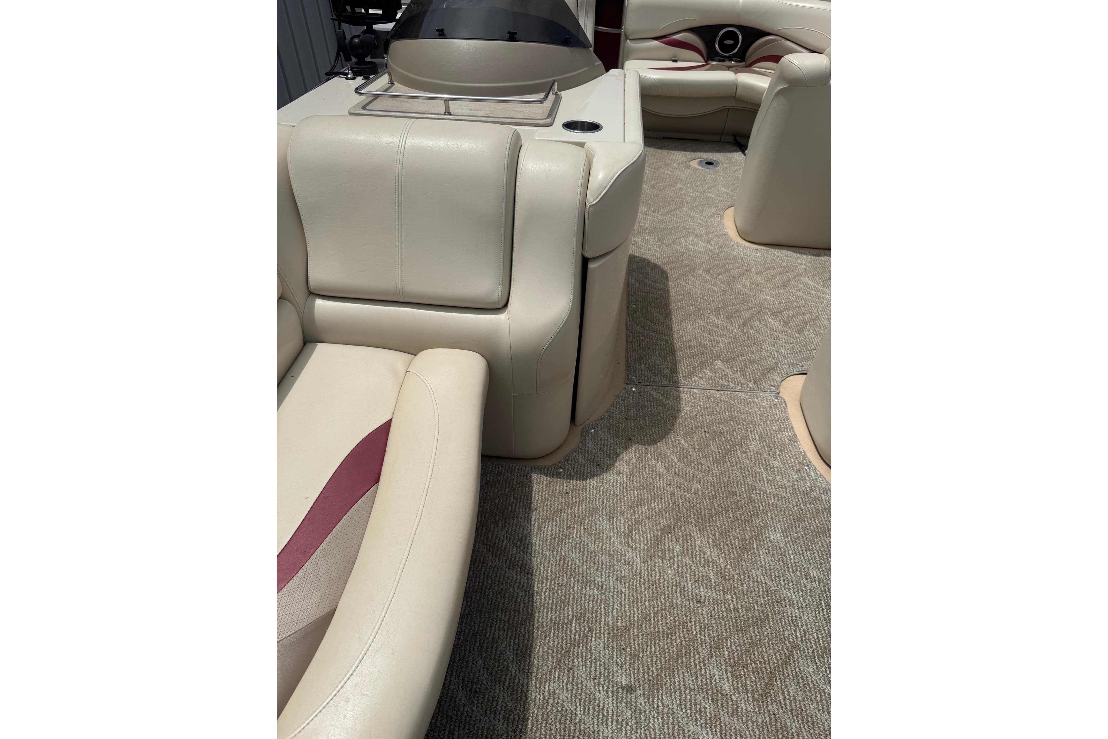 Interior of 2008 Sylvan 8523 Mandalay RE pontoon boat with beige seating.