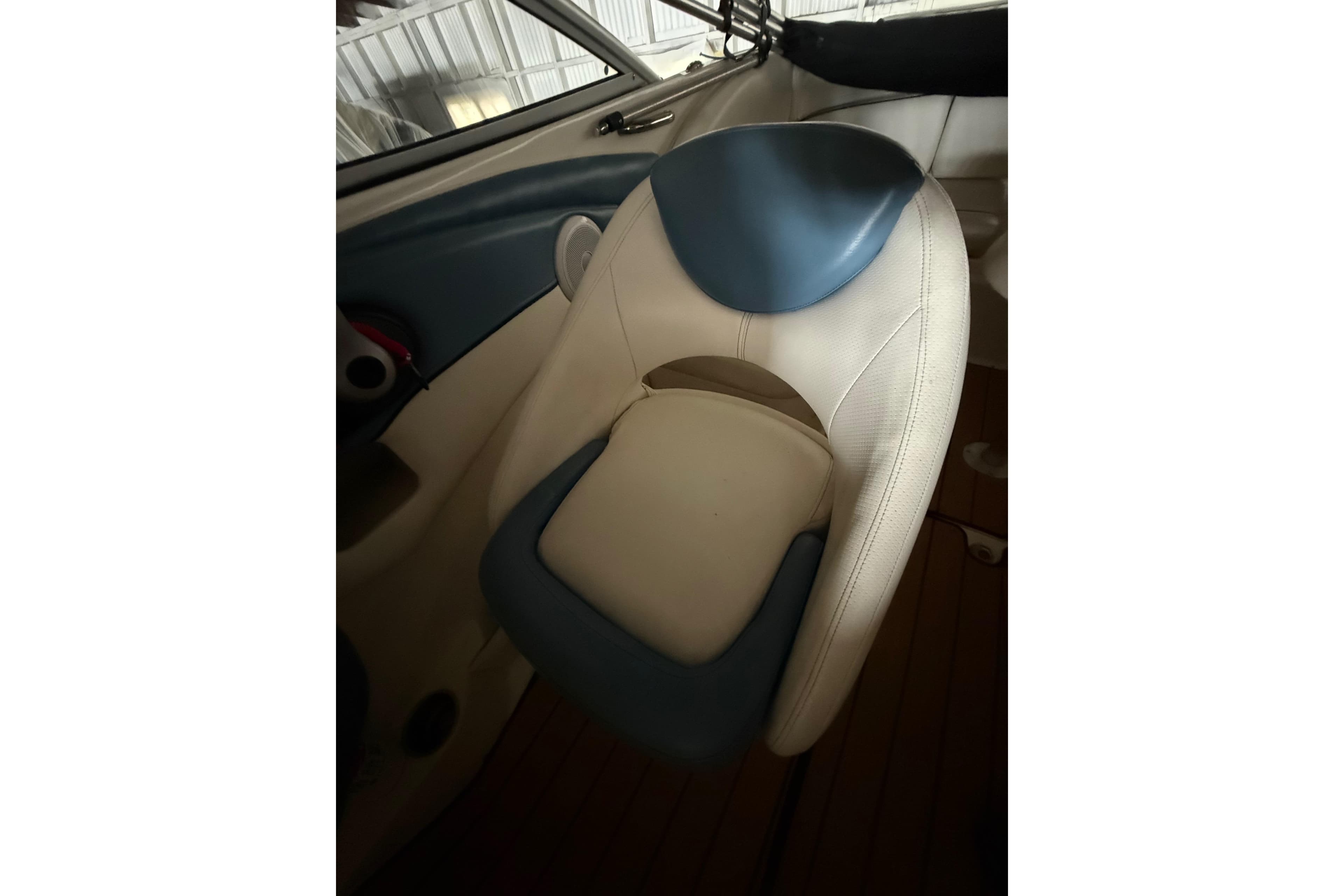 2012 Bayliner 235 Bowrider interior seat with blue and white upholstery.