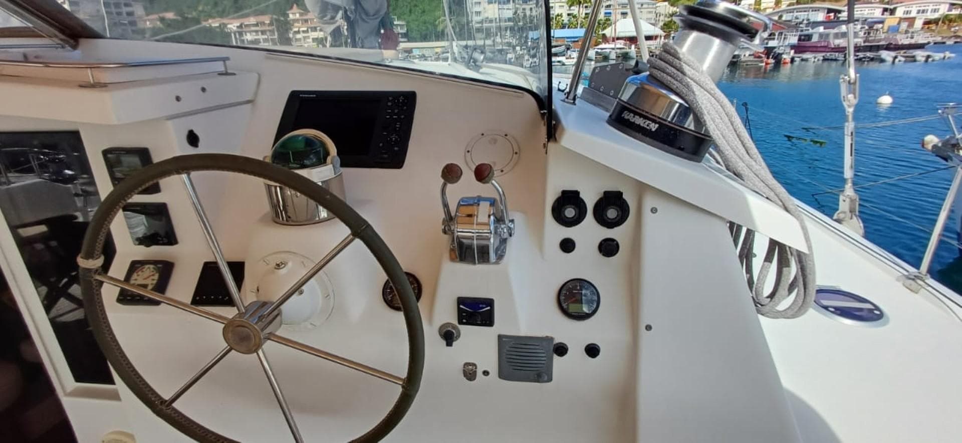 Helm of 2008 Fountaine Pajot Eleuthera 60 catamaran with steering wheel and navigation controls.
