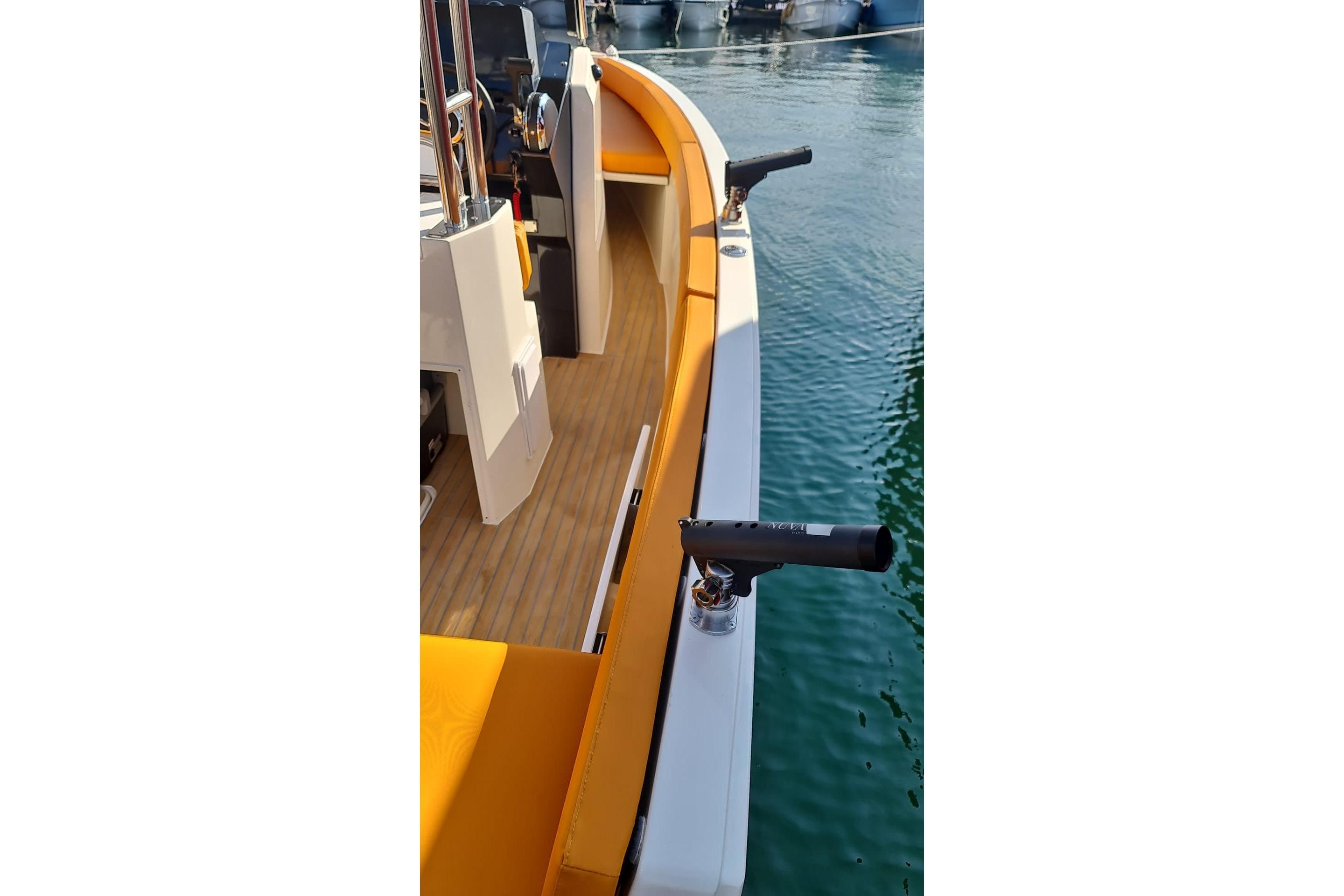 2025 NUVA YACHTS M6 Fisher boat deck with orange seating and rod holders.