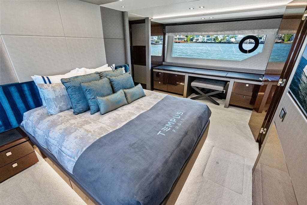 Luxurious bedroom interior of 2019 Sunseeker 76 Yacht with waterfront view.