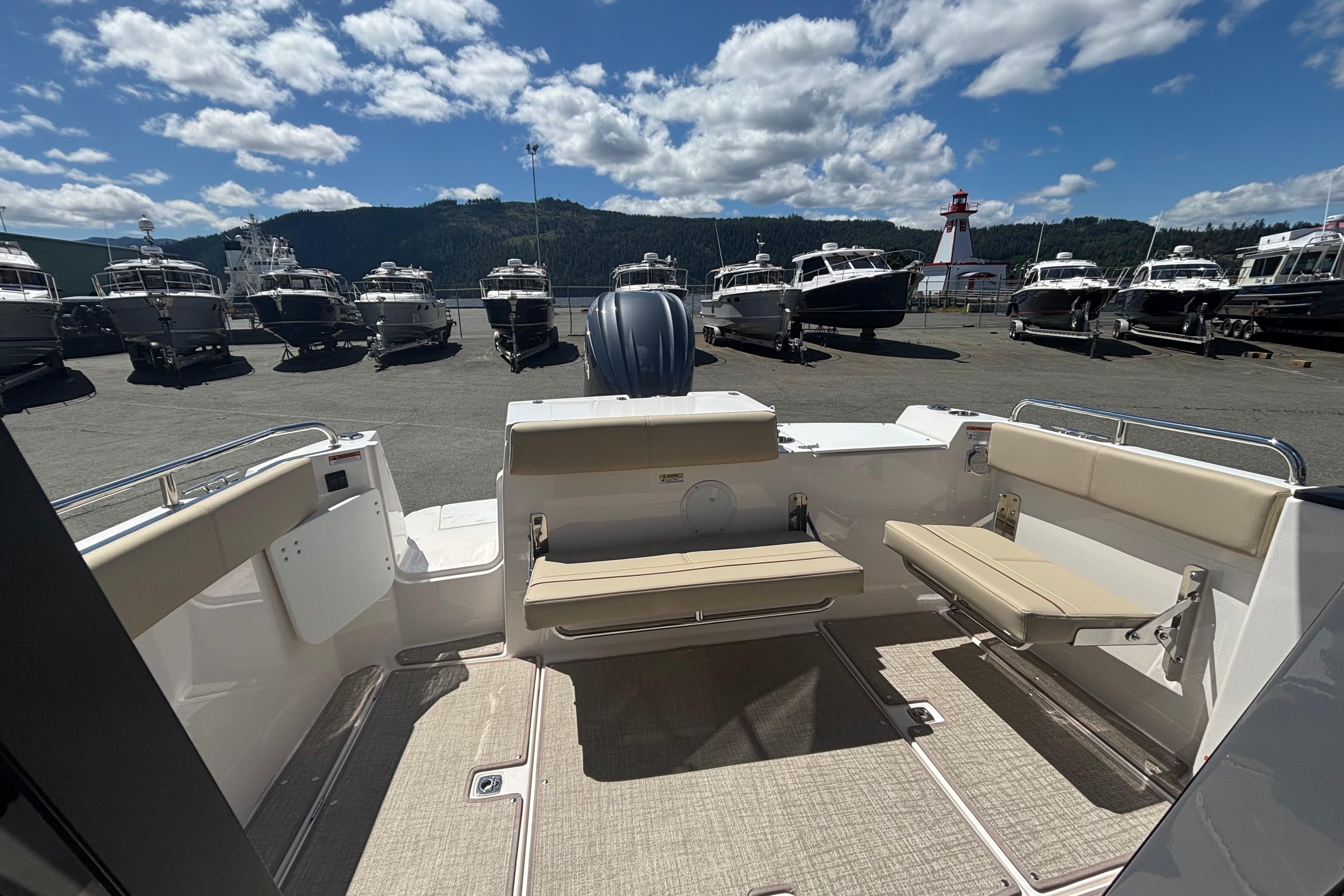 2026 Cutwater C-248 Coupe boat interior with seating, docked under a blue sky.
