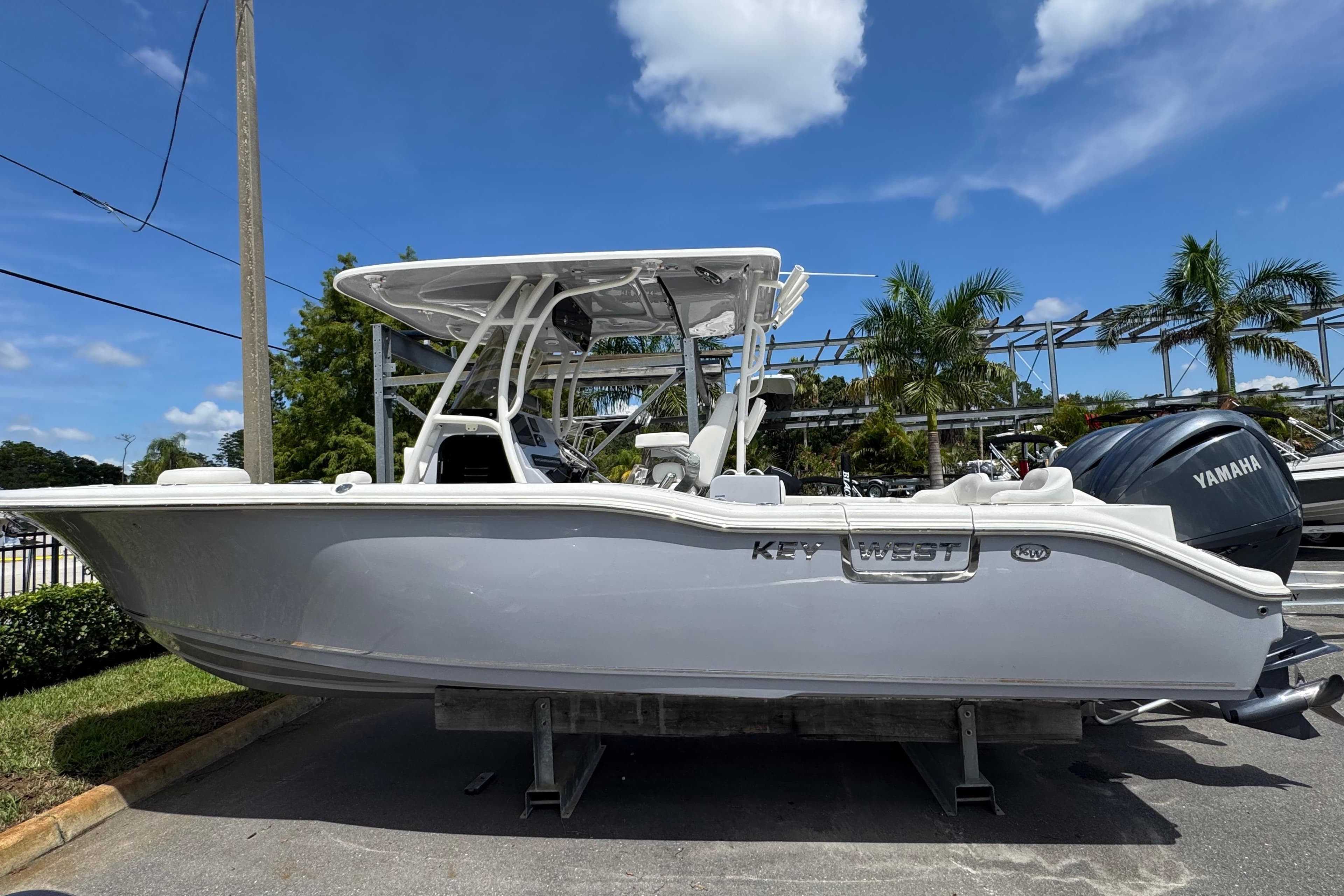 2025 Key West 263 FS boat with Yamaha engine, parked outdoors under a clear blue sky.