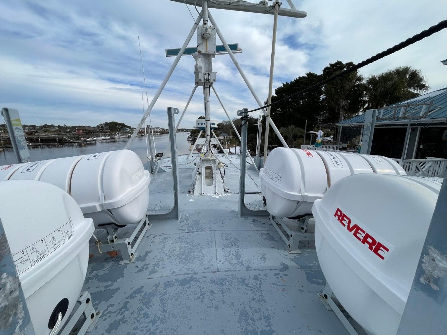 1972 Swiftships Commercial Passenger vessel deck with lifeboats and scenic waterfront view.
