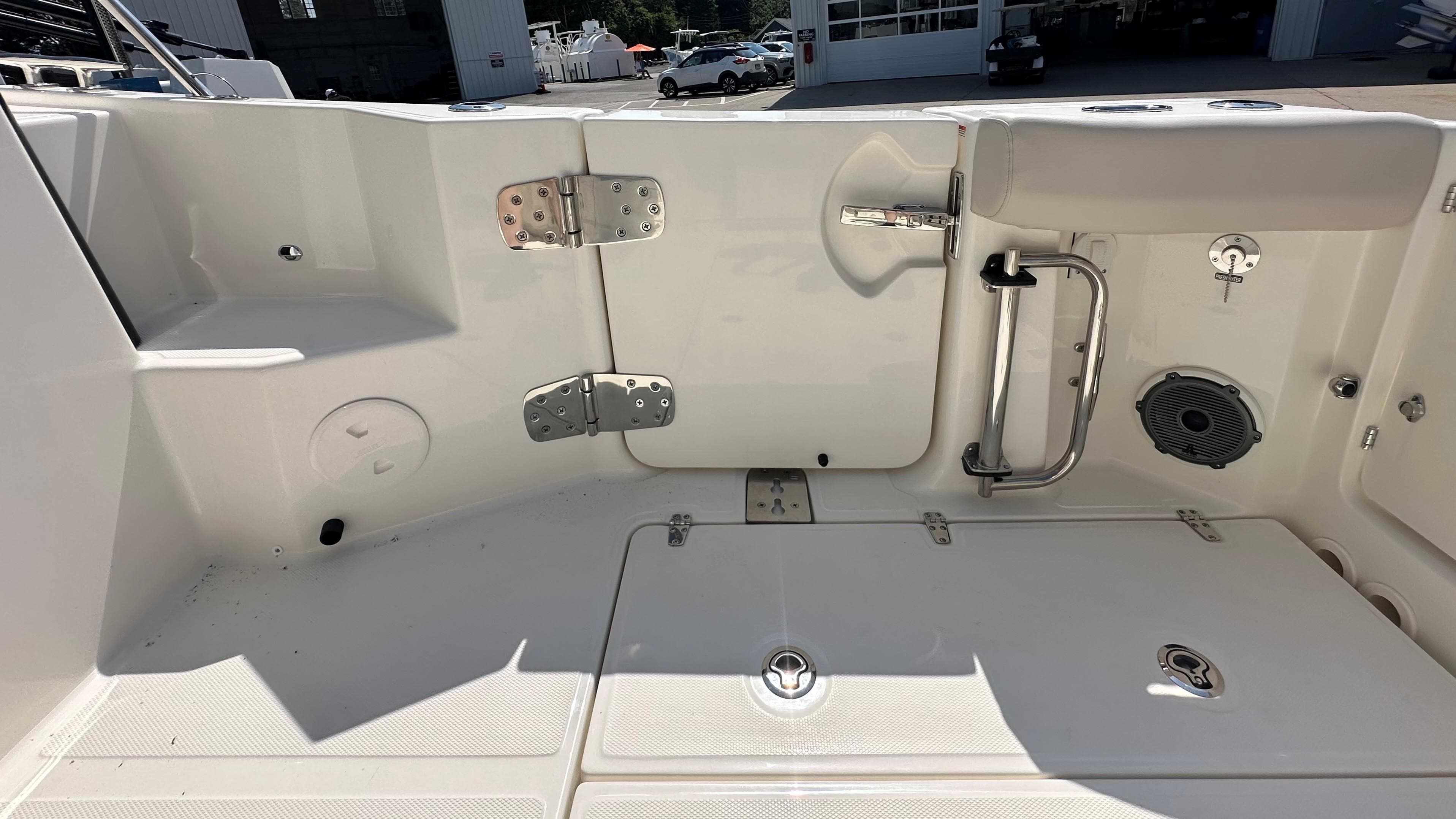 2026 Boston Whaler 325 Conquest boat deck with storage compartments and stainless steel fixtures.