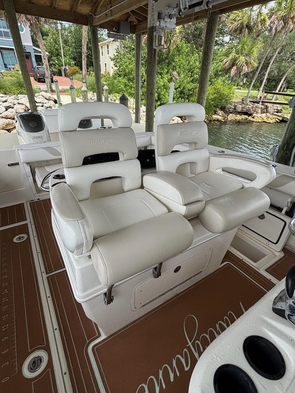 2006 Boston Whaler 320 Outrage boat interior with white seating and brown flooring.