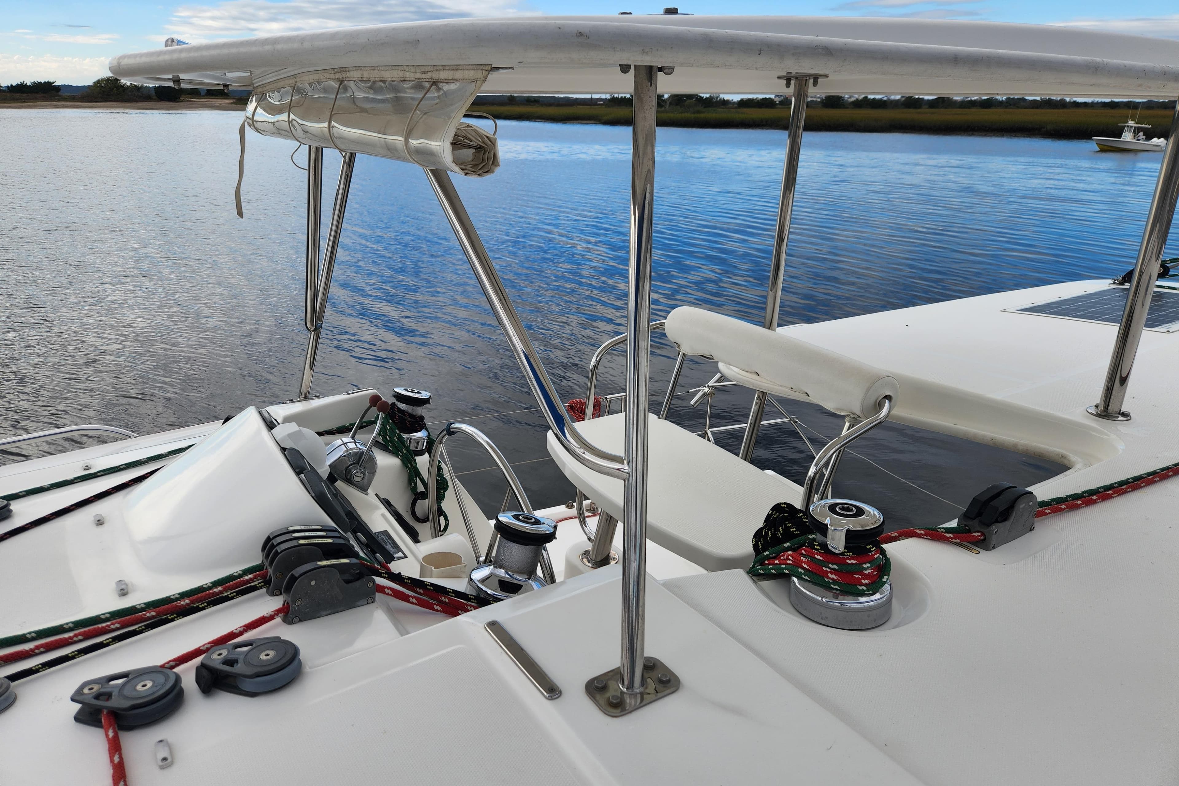Sailing catamaran Leopard 44, 2015 model, docked on calm waters with visible rigging.