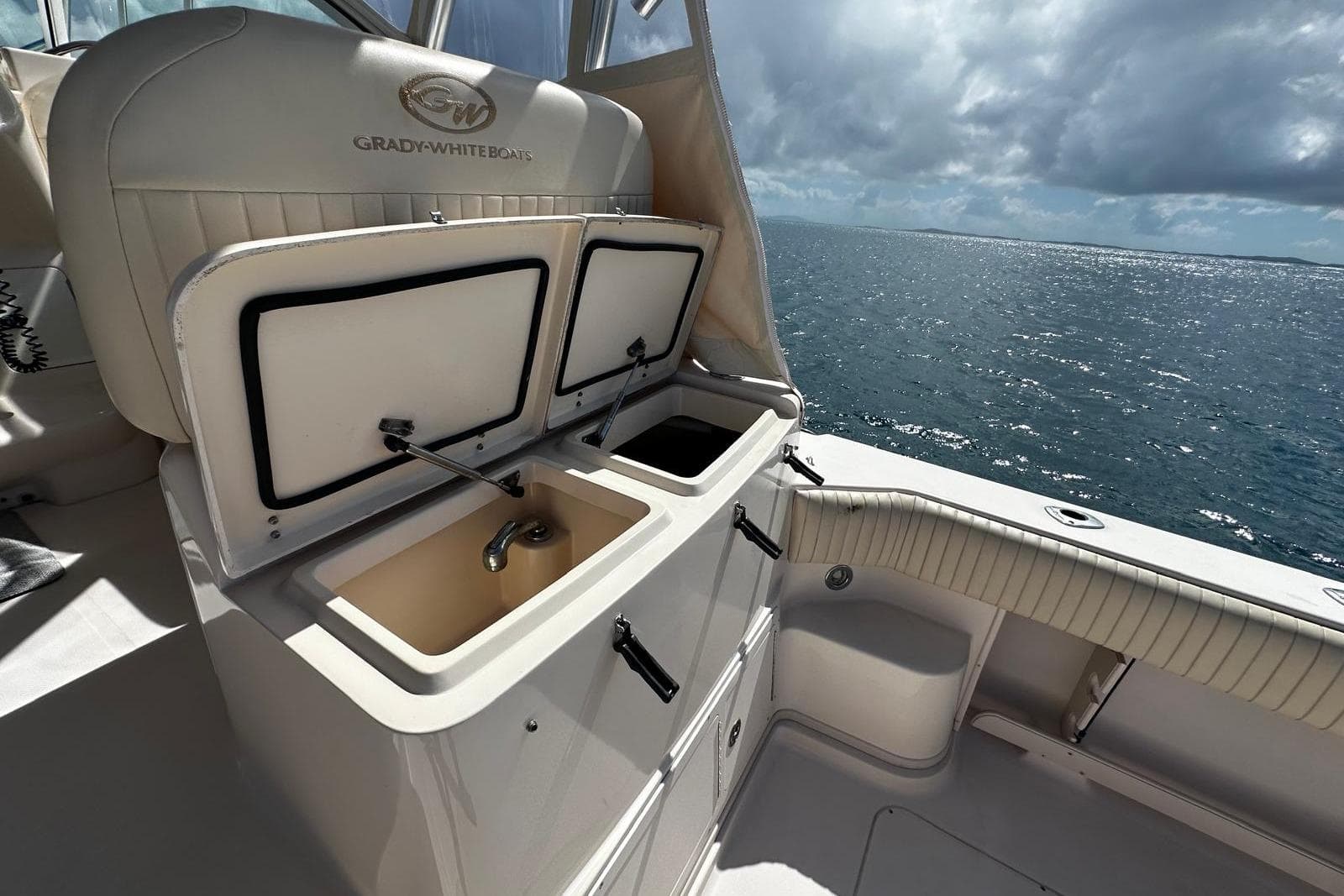 2006 Grady-White Express 360 boat interior with open storage compartments, ocean view.