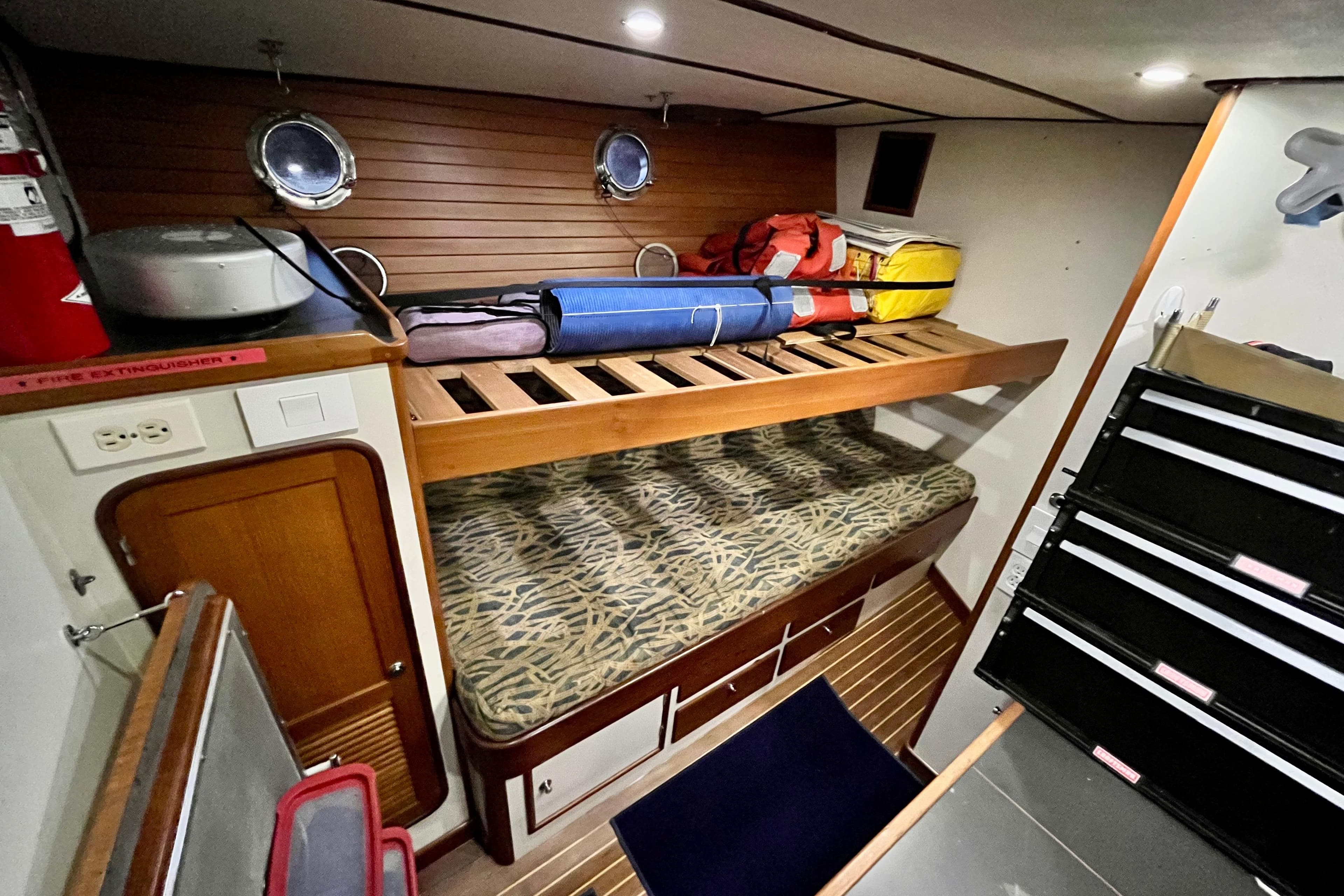 Cozy cabin interior of 1996 Nordhavn 46 yacht with bunk beds and storage.