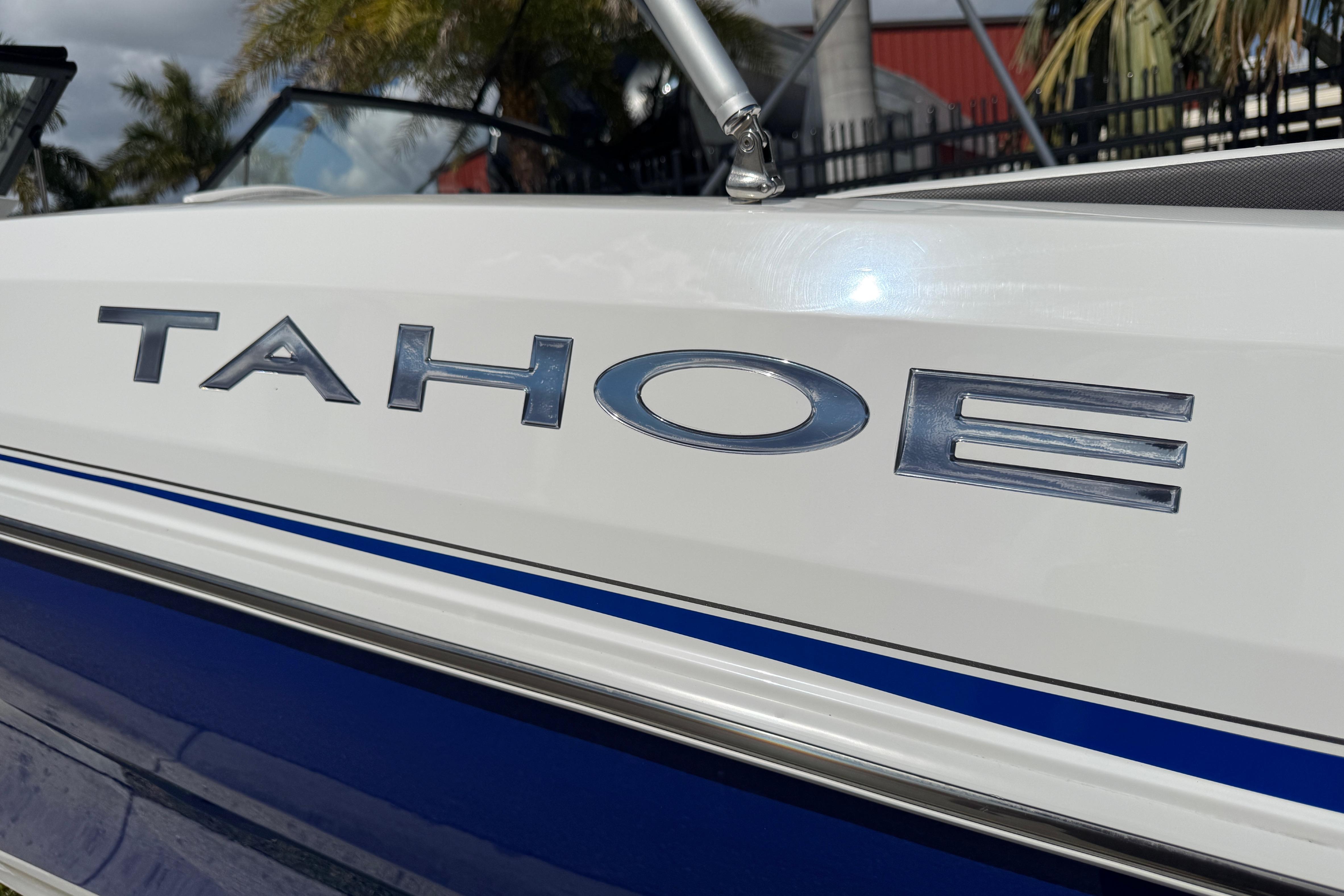 2024 Tahoe 185 S boat, close-up of logo on white and blue exterior.