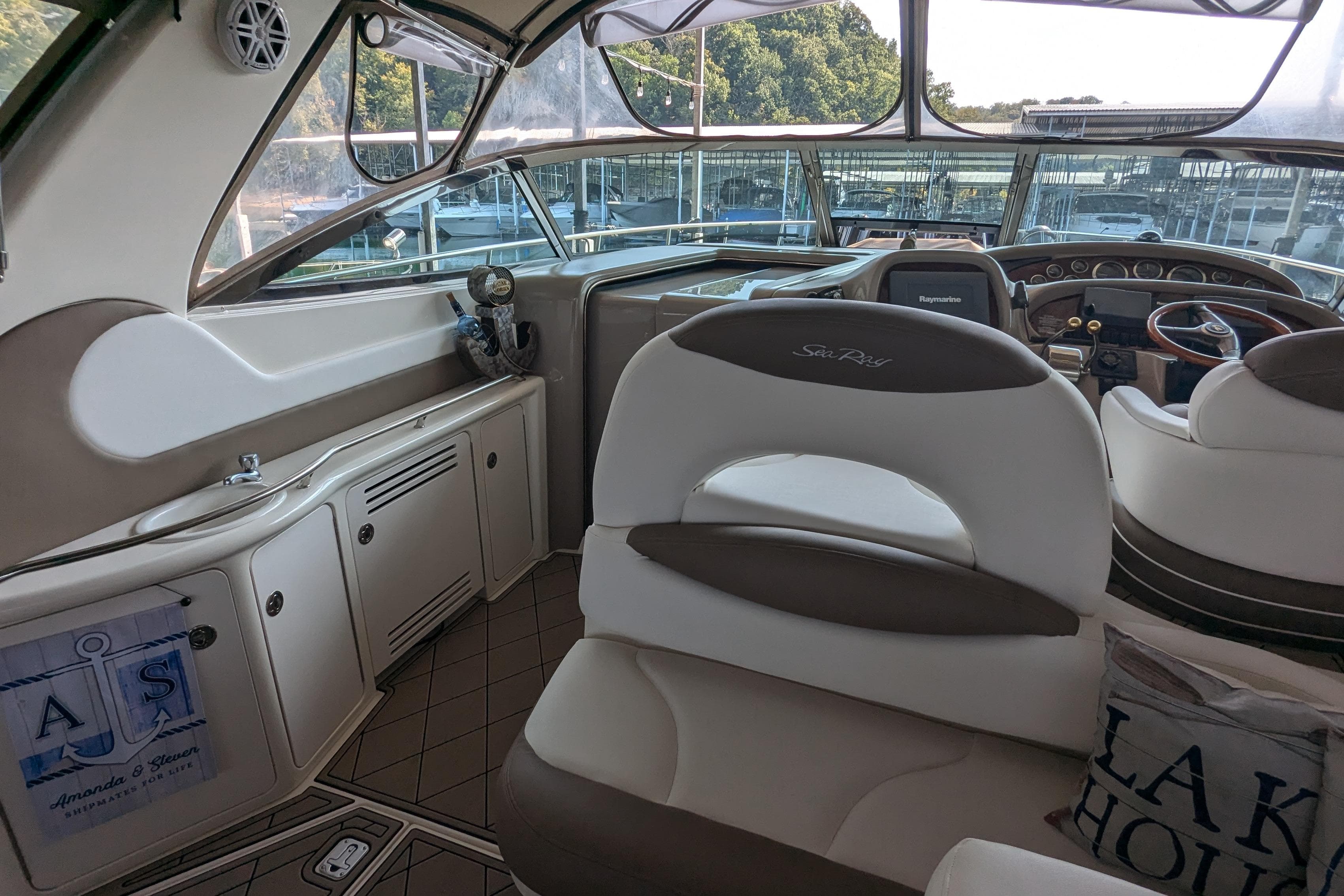 Interior of a 2000 Sea Ray 380 Sundancer yacht with helm and seating area.
