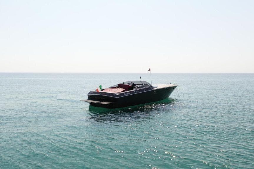 1991 Magnum 53 yacht cruising on calm ocean waters under clear skies.