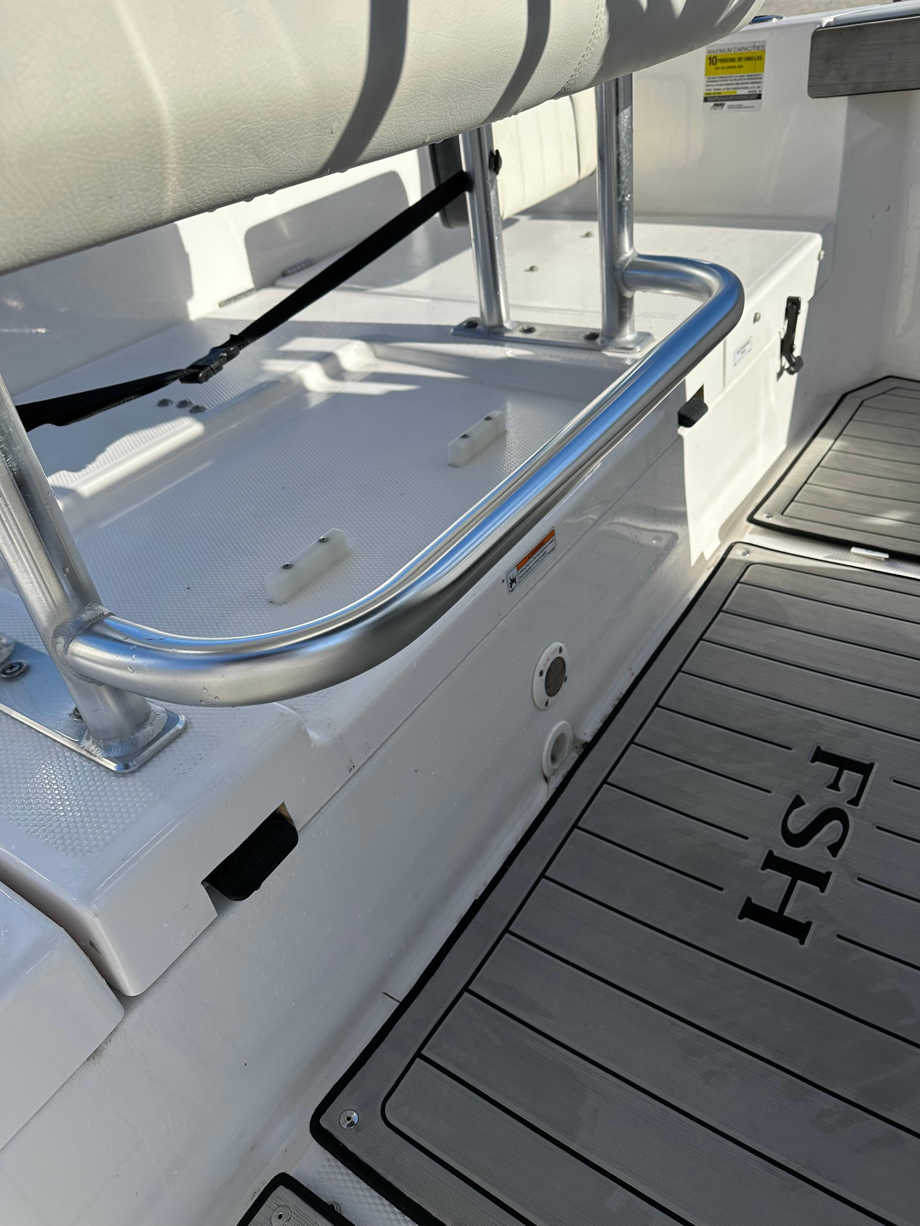 2021 Yamaha Boats 210 FSH Sport interior, featuring seating and deck details.