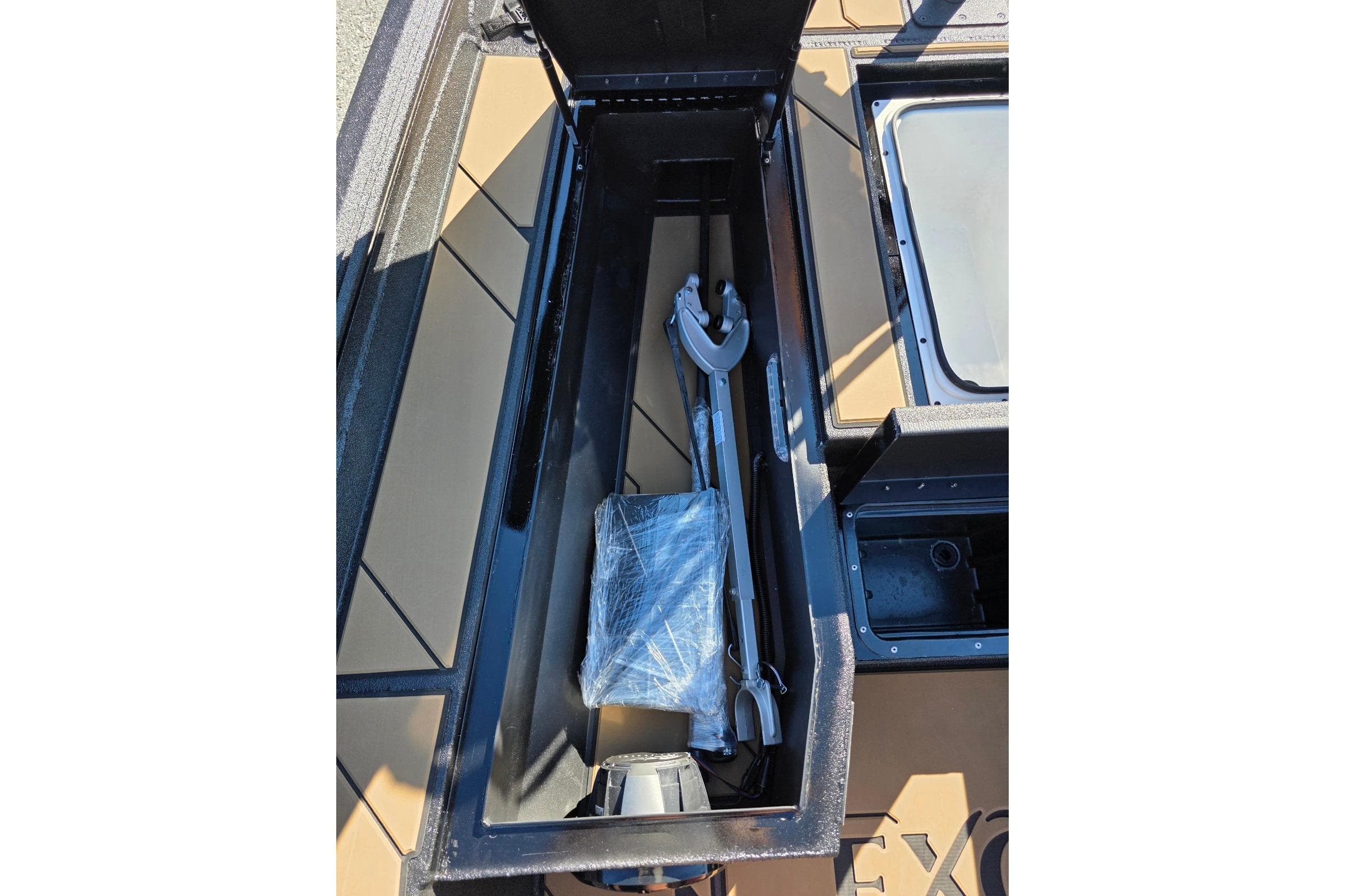 Storage compartment of 2026 Excel EX 183 boat with equipment inside.