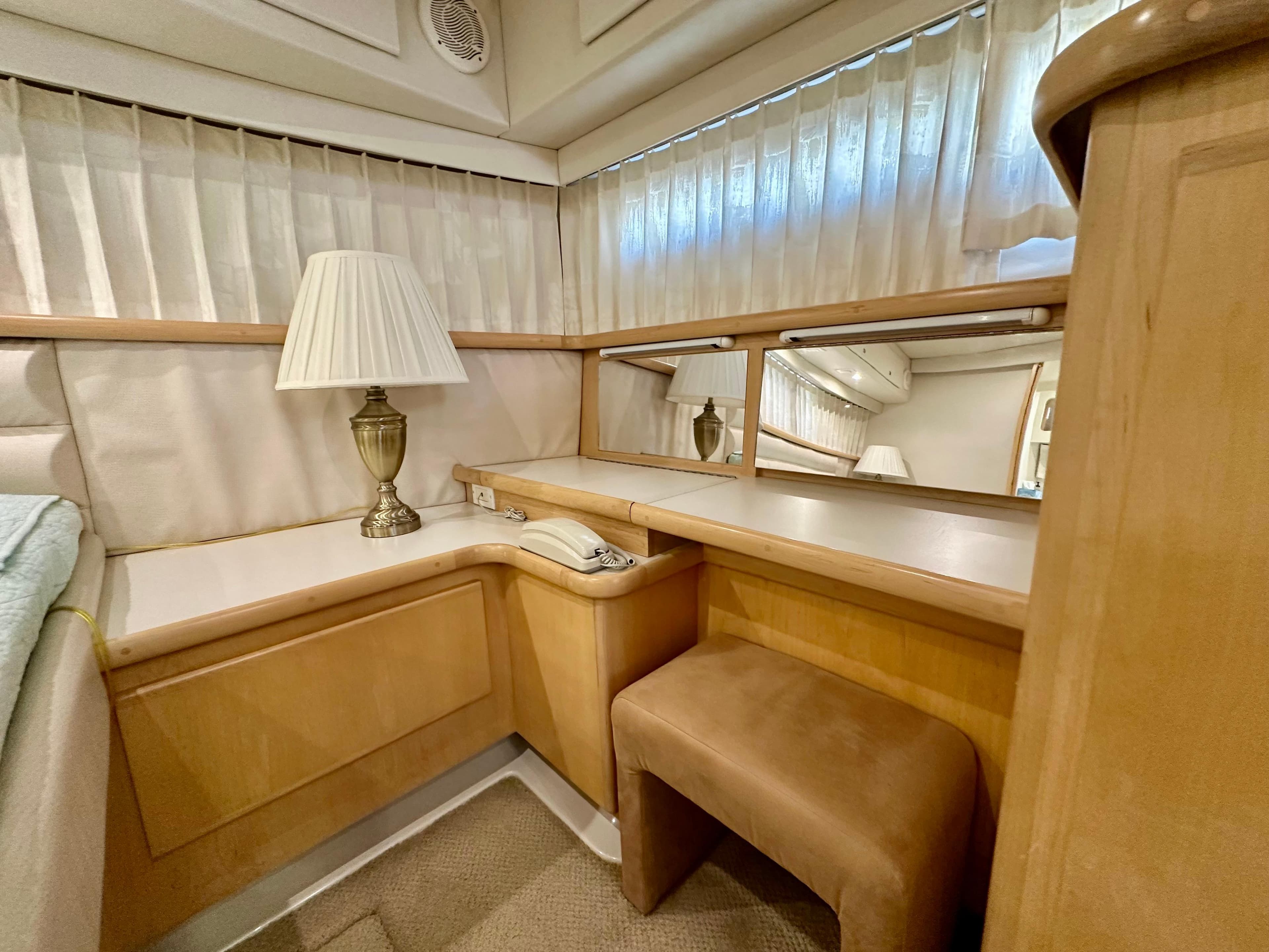1995 Carver 440 Aft Cabin Motor Yacht interior with vanity, lamp, and mirror.