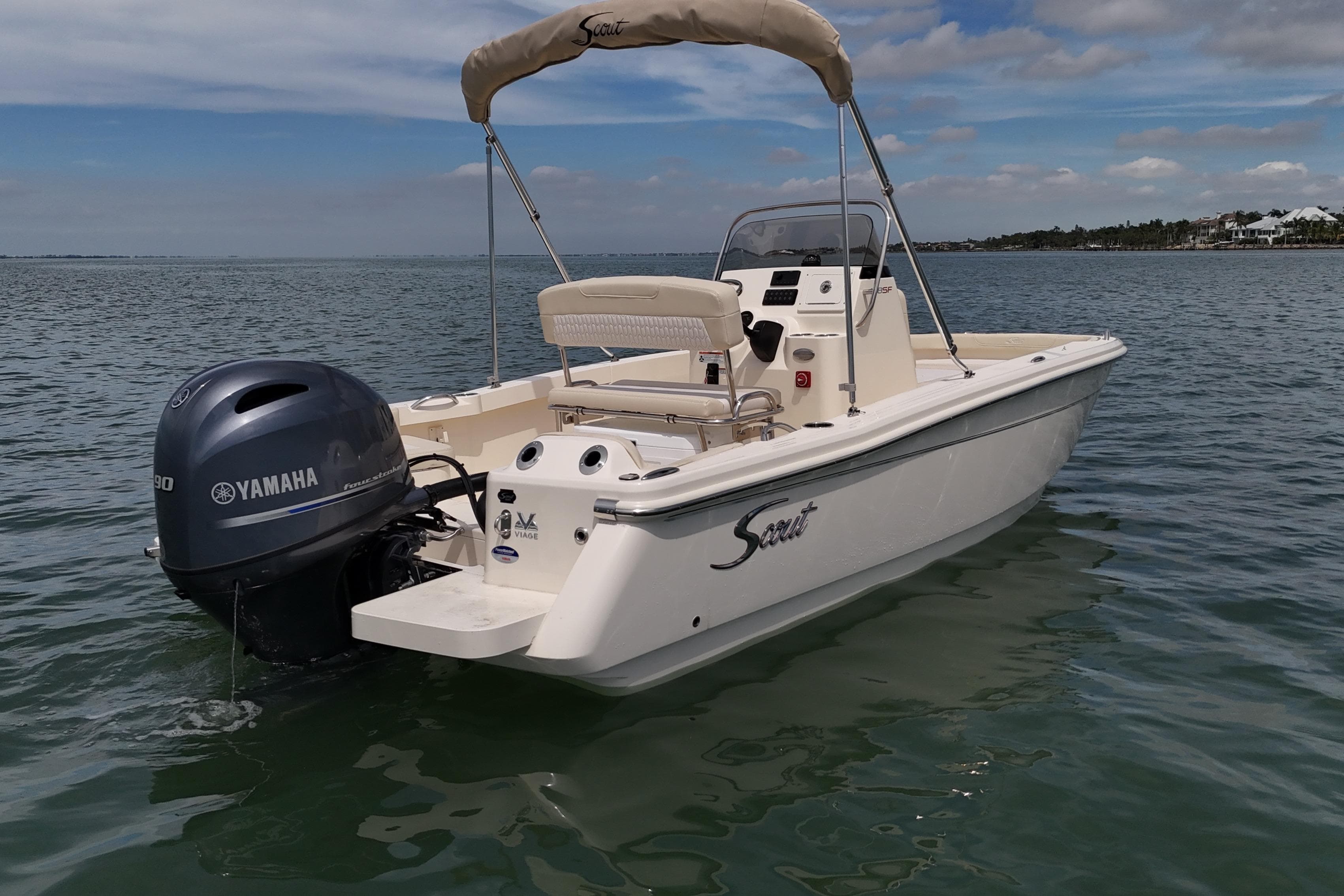 2026 Scout 188 Sportfish boat with Yamaha engine on calm water.