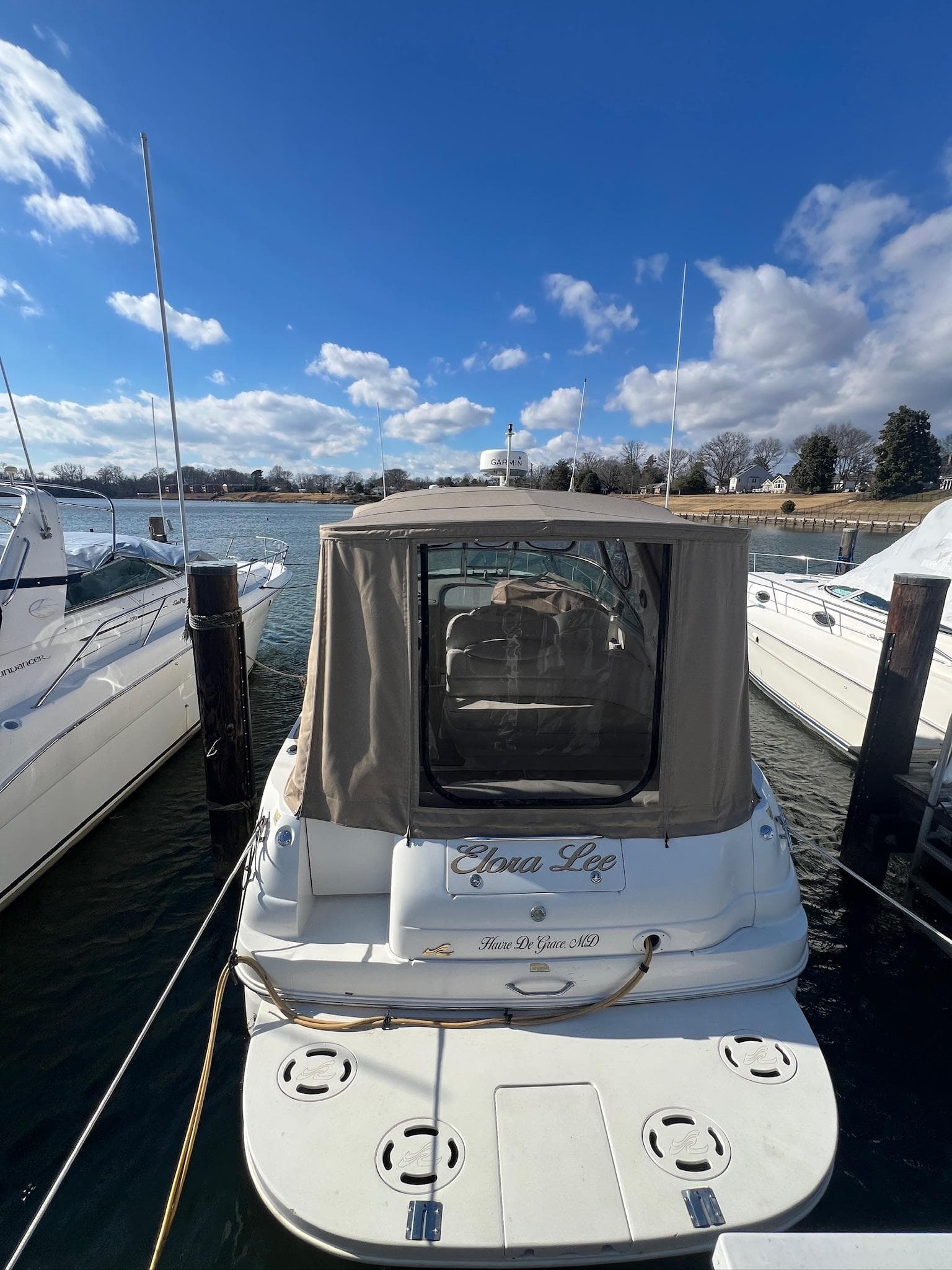 2001 Sea Ray 340 Sundancer docked under a clear blue sky.