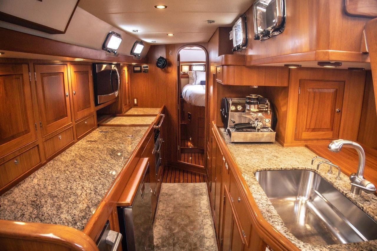 Luxurious 2012 Hylas 56 yacht interior with wood cabinetry and granite countertops.